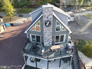 GREAT LAKE ESCAPE waterfront living is just waiting for you! Fully furnished active & very successful STR offers 4 seasons of lake fun-boat, fish, swim, ski-it's all yours. Large sunny granite kitchen, family room & game room, decks and outdoor fire pit & more-with 8BRs/5 baths & all the room you need for family, friends and guests, it's a one of a kind space so come jump in the lake, I've got the key!
