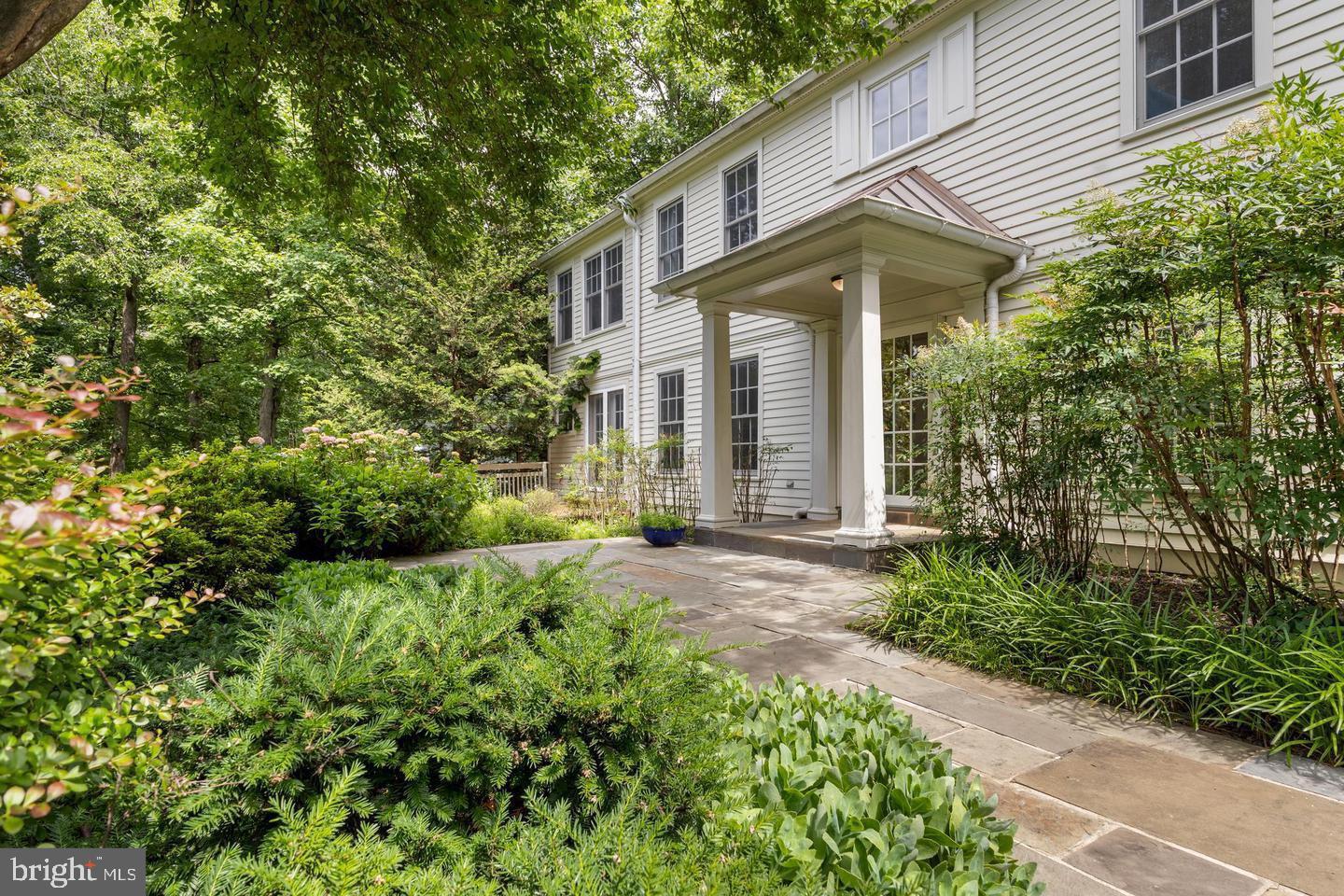 Welcome to 11103 Burywood Lane, a truly one-of-a-kind custom residence where timeless craftsmanship, sophisticated design, and serene natural surroundings come together in one of Reston's most coveted neighborhoods. Extensively expanded and renovated in 1998, this exceptional home showcases extraordinary attention to detail with rich custom millwork, elegant wainscoting, built-in bookcases, pocket doors, custom cabinetry, French and glass doors, generous walk-in closets, and refined finishes rarely found in today's homes. Situated on a beautifully landscaped 0.59-acre lot, the setting offers a peaceful, park-like retreat while remaining just minutes from Reston Town Center, Metro access, major commuter routes, and the region's thriving technology corridor.  Completing the package is its location in the prestigious Langley High School pyramid, offering access to one of the area's top-rated public school systems.

The impressive main level is designed for both elegant entertaining and everyday living, featuring a grand foyer, an expansive formal dining room, a stunning library, and two private office spaces, including one with its own exterior entrance, making it ideal for today's work-from-home lifestyle or client meetings. The gourmet kitchen is a chef's dream with a large granite island, abundant custom cabinetry, premium Sub-Zero refrigerator, Gaggenau cooktop, double ovens, and exceptional workspace that opens seamlessly into the home's inviting living areas.

Retreat upstairs to the luxurious primary suite featuring soaring cathedral ceilings, custom accent lighting, a built-in entertainment center, dual oversized walk-in closets, and a spa-inspired bath designed for ultimate relaxation. Four additional spacious bedrooms provide comfort and flexibility for family and guests alike.
The walk-out lower level is filled with natural light and offers endless possibilities with abundant finished space for a recreation room, fitness studio, media room, additional bedroom, or guest suite. Additional luxury features include a temperature-controlled wine cellar, an authentic Finnish sauna, motion-activated hallway lighting, extensive custom storage throughout, and an oversized garage with elegant carriage-style doors.

Located within the highly acclaimed Langley High School pyramid and surrounded by Reston's miles of wooded trails, parks, lakes, and vibrant community amenities, this remarkable residence offers a rare opportunity to own a private sanctuary that perfectly balances luxury, tranquility, and convenience. Every space has been thoughtfully designed to create a home that is as functional as it is beautiful, delivering an unparalleled lifestyle in one of Northern Virginia's most desirable communities.