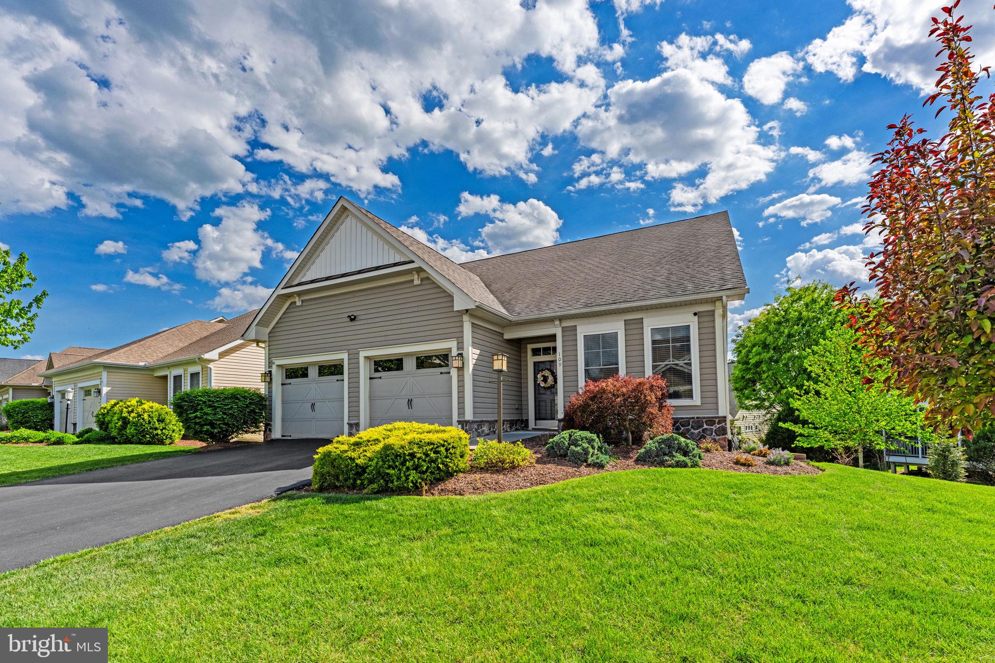 Great home. Great neighborhood. Even better price!! Welcome home to 109 Tutelo Lane, an immaculately maintained ranch-style residence nestled in the premier 55+ community of Trilogy at Lake Frederick. Boasting incredible curb appeal with lush greenery and mature trees, this residence is just steps from the lake and offers a lifestyle defined by luxury and convenience.  The exterior serves as a private oasis, featuring a rear Trex deck with elegant white railings, a lower-level brick patio, and a pristine yard enclosed by premium white vinyl fencing. Inside, the freshly painted interior is bathed in natural light, showcasing a sophisticated floor plan that begins with a versatile formal living room off the foyer. This space flows into a striking formal dining room wrapped in a rich navy-blue, providing a beautiful backdrop for hosting guests, before entering the heart of the home: an expansive, open-concept family room and gourmet kitchen.  A chef’s dream, the kitchen features a massive quartz island with integrated seating, stainless steel appliances, a corner pantry, and a sun-drenched breakfast area where glass doors open to the deck for effortless indoor-outdoor dining. The main level is designed for effortless living, highlighted by a sprawling primary suite with a large walk-in closet and a gorgeous, recently updated ensuite bath. This spa-like space is anchored by an extra-long vanity featuring upgraded countertops, sleek dual sinks, and an impressive amount of cabinet storage and drawer space, all complemented by a massive walk-in shower with exquisite custom tilework. A second spacious bedroom, a full guest bath, and convenient laundry facilities complete the first floor. Head downstairs to the expansive walk-out finished basement, where the possibilities are endless. This level features a large recreation room with built-in cabinetry, a versatile den/bonus room, a sizable half bath, and a dedicated hobby/craft room currently outfitted with incredible storage and workspace—perfect for a playroom, home office, or gym. Modern essentials are already in place, including a security system and satellite dish, plus an attached two-car garage finished with sleek epoxy-coated flooring. Trilogy at Lake Frederick offers an unparalleled resort experience right at your doorstep. You will enjoy exclusive access to the world-class Shenandoah Lodge, award-winning dining at Region's 117, a state-of-the-art fitness center, and both indoor and outdoor pools. Whether you are taking advantage of the sports courts, dog park, or the miles of scenic walking trails and lake access, the amenities are truly unmatched. Perfectly situated near major commuter routes, shopping, and dining, this home offers the ideal balance of tranquil lakeside living and modern accessibility.
