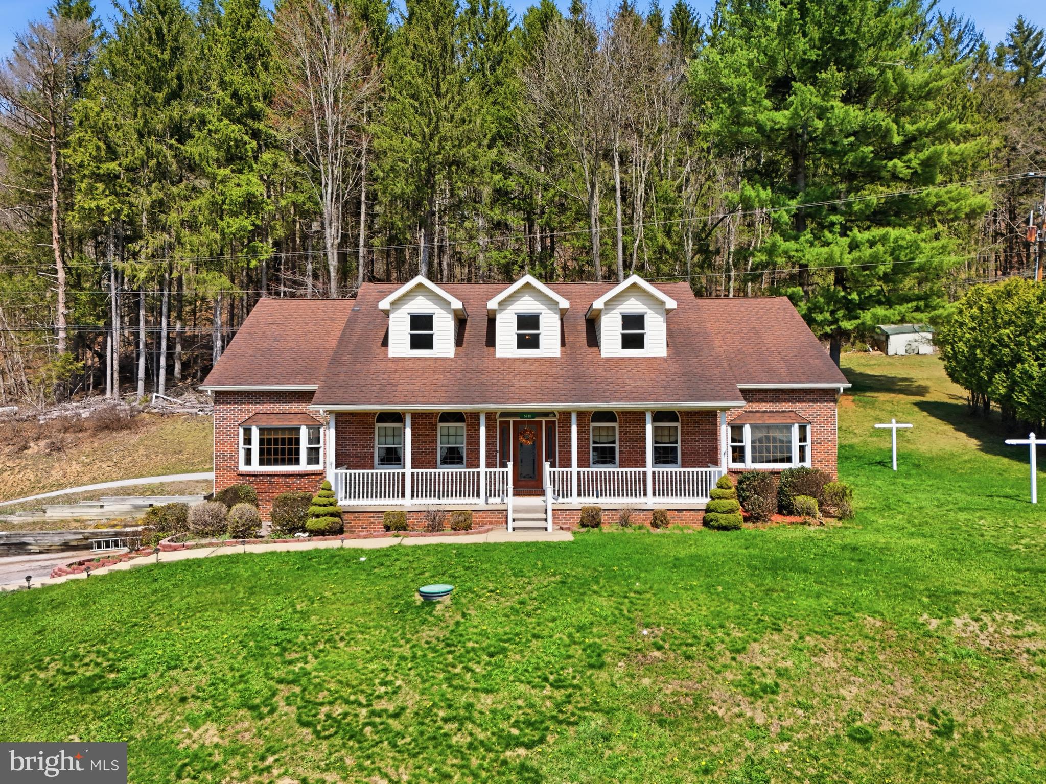 This 2,855+ sq ft brick beauty in Clearfield sits gracefully along a serene 3 acre wooded backdrop, offering both privacy and timeless appeal. From the front entry, you’re welcomed by hardwood floors flowing through the foyer, dining room, and spacious eat in kitchen. The kitchen is designed for both cooking and gathering, featuring a large island, pantry, and stainless steel appliances. A generous living room anchors the main level, while a first floor office with built in storage provides an ideal workspace. The first floor owner’s suite delivers true comfort with a soaking tub, separate shower, double sinks, and a walk in closet, complemented by a convenient powder room nearby. Upstairs, two well sized bedrooms with large closets and a full bath create a perfect second level retreat. Outdoors, a rear covered patio gently meets the edge of the woods, offering a peaceful setting enhanced by a gas fire pit. Additional highlights include a two car integral garage, full basement, updated major mechanicals, central AC, natural gas heating, sand mound, and public water - all combining to make this property a rare blend of space, setting, and modern comfort. There is so much more to explore here, come experience what this home has to offer today!