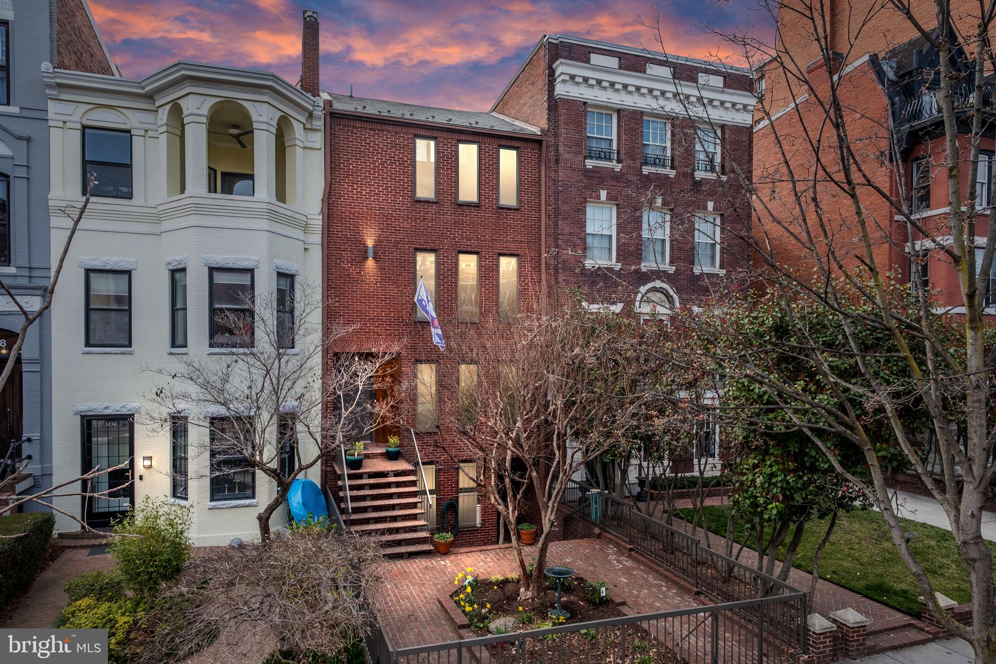 On the market for the first time ever, this multi-family contemporary gem provides for the perfect oasis of quiet and peace in the heart of Dupont. Built in 1977 and designed by architect John Sullivan, this home boasts 3 income-generating apartments in addition to the owner’s 3BR 2.5BA townhome. The main house is an exquisite example of light-filled open concept with soaring ceilings & skylights, and has been newly updated to modern tastes. Refinished original hardwood floors, fantastic exposed brick walls, and fresh paint throughout. The entry level is an entertainer’s dream, complete with flowing living and dining spaces, and culminating with dramatic cathedral ceilings and floor-to-ceiling windows. Refreshed and spacious eat-in kitchen with new counters, custom backsplash and newly painted cabinetry. A lofty 3-level floating staircase leads up to the library, which overlooks the living room and includes large swathes of built-in shelves awaiting your books and treasures. The upper levels also host 3 bright and spacious bedrooms (including 2 potential primary suites), and two ensuite baths upgraded with new counters and custom tile. This home’s ample outdoor spaces are truly special, and include a central courtyard & garden, front brick patio, and expansive rooftop deck. The rear garden is enveloped by high walls covered with Wisteria & Hydrangea. The massive Bradford Pear tree’s shade creates a feeling of protection and softness in the backyard. Meanwhile the rooftop deck is sunny and open while still maintaining privacy, and is an ideal spot for the urban gardener in you. This space could also be converted into a 4th bedroom!

Complementing the primary residence are 3 apartments, each 1BR 1BA and approximately 900SF in size. 2 of the 3 units have been substantially renovated within the past 3 years. Top floor apartment of the carriage house features cathedral ceilings and a brick fireplace. For the savvy investor, economic upside possibilities abound with so many spaces! Traditional rentals, tons of AirB&B opportunities, perhaps convert the garages into a 5th unit, or even break the property into condos.

The home includes tons of parking (7 total spaces, including a storage area converted from a garage space), 2 additional storage closets off the garage space, and a very functional rear alley with easy access to R and S Streets. Ideally located in the heart of vibrant Dupont Circle. Explore cafes, restaurants and bars on 18th St, U St and 14th St. 1 block to Mint Gym. Enjoy the weekend Farmer’s market on Columbia Rd and Dupont Circle. Transit oriented location with Metro buses on 18th Street and Metro stations nearby (0.7mile to Dupont and U St/Cardozo).