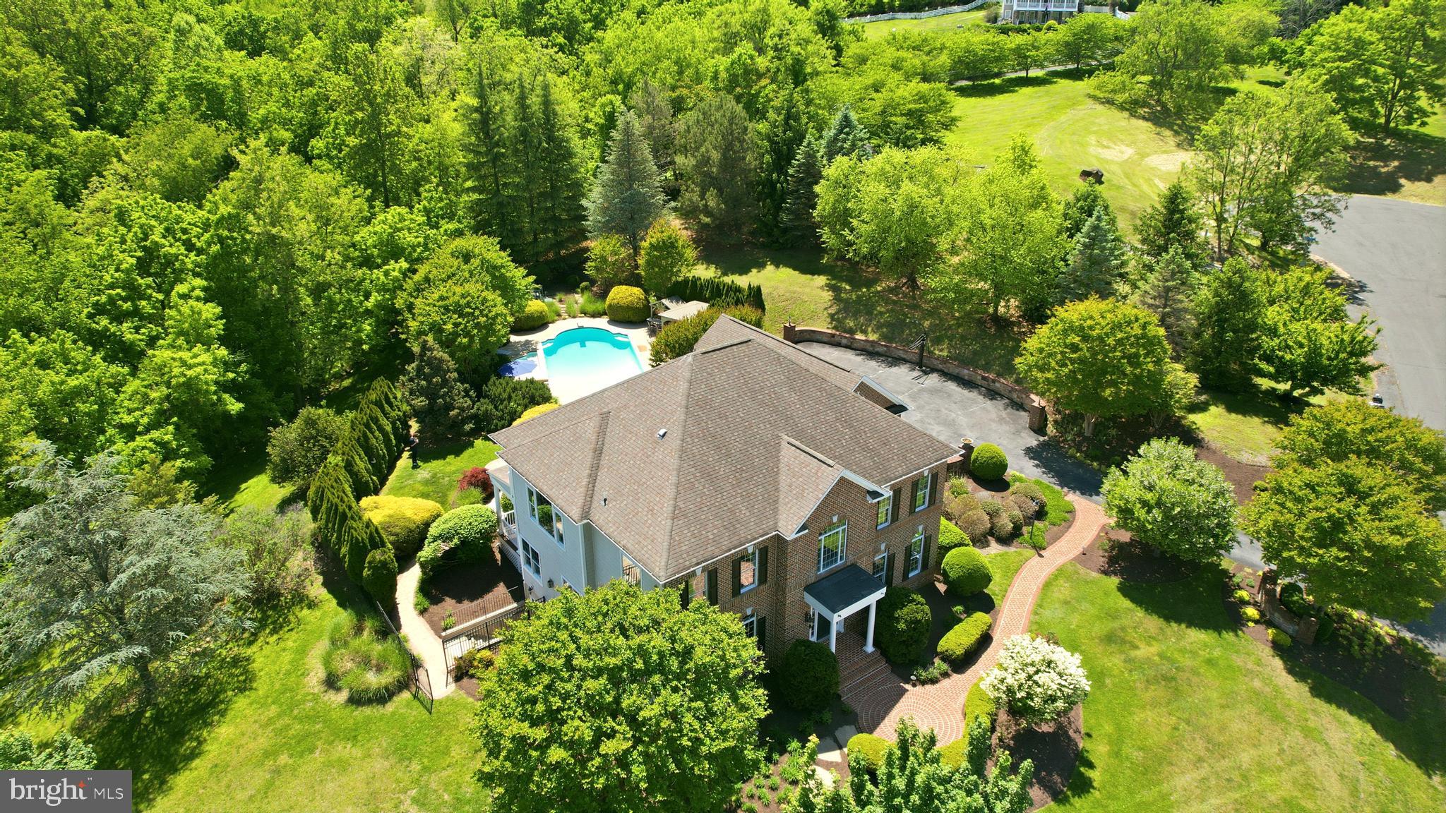 ✨ Experience resort-style living in this custom-built brick estate set on over 1.6 acres in the prestigious Stoneleigh Country Club. Perfectly sited on a private, elevated, north-facing corner cul-de-sac lot, the home overlooks the Par-5 15th hole with sweeping pond & mountain views. The backyard retreat features a spectacular heated pool, spa, & outdoor entertaining spaces designed for entertaining. Updated in 2026, this exceptional residence offers 4,812 finished square feet, 5 bedrooms, 4 full baths, 1 half bath, & a 3-car side-load garage, creating a truly turnkey luxury property with over $200,000 in recent improvements.

Upon entry, a grand oak staircase & soaring 2-story foyer set the tone for the home’s timeless architectural details. Wide-plank flooring spans the entire main level, while hardwood flooring extends throughout the upper level. Elegant formal living & dining rooms provide ideal spaces for everyday living & entertaining. The formal living room features elegant built-in bookcases & flexibility for a home office, while the inviting family room offers a cozy fireplace with granite surround, window seating, & natural light.

🍽️ The redesigned gourmet kitchen is a showpiece, featuring white shaker cabinetry, quartz countertops, a stunning 8-foot center island, classic white subway tile backsplash, & all new stainless steel appliances. The light-filled morning room features a coffee bar with cabinetry. A French door leads to the spacious covered porch overlooking the backyard—perfect for morning coffee or evening gatherings.

🛌 Upstairs, the primary suite is a true retreat, offering a tray ceiling, walk-in closets with custom closet systems, balcony access, & a renovated spa-inspired bath with a quartz-topped double vanity, freestanding soaking tub, & large frameless glass shower. Double French doors lead to the balcony overlooking the pool & backyard.

The upper level also includes 3 additional generously sized bedrooms, each featuring customized closet organizers. Bedrooms 2 & 3 share a renovated Jack-and-Jill bath, while the spacious princess suite features its own updated en-suite bath.

🎬 The finished walk-up lower level expands the home’s versatility with a spacious recreation room featuring a gas fireplace, flex space ideal for a gym or office, & a private fifth bedroom or in-law suite complete with a walk-in closet & full bath.

The backyard retreat features an impressive 38,000-gallon heated pool with 8.5-foot depth & diving board, spa, travertine pool deck, & newly added cedar gazebo with bar. Black wrought iron fencing & extensive landscaping & hardscaping—including a stamped concrete patio & retaining wall—create a private setting.

📍 Located within the sought-after Stoneleigh Country Club, residents enjoy access to world-class amenities, including a championship golf course, clubhouse, tennis courts, & swimming pool. Ideally situated, this home is just 30 minutes from Dulles Airport & minutes from Route 7, providing easy access to shopping, dining, & entertainment.

With low HOA dues of just $75 per year & the convenience of public utilities—no well or septic to manage—this extraordinary property delivers the perfect blend of luxury, convenience, & tranquility.