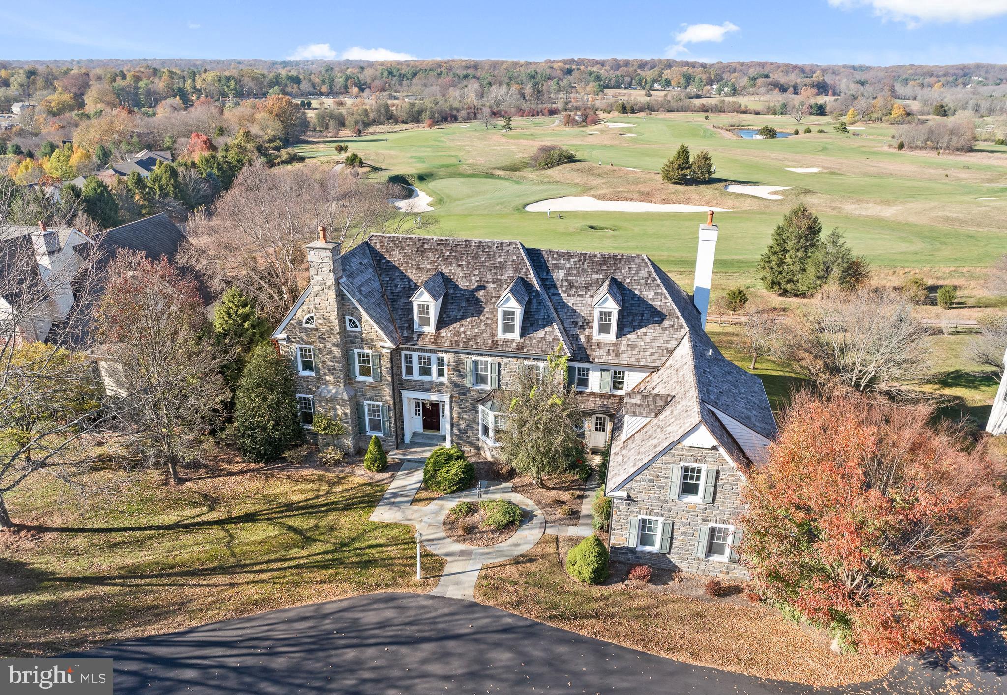 New Price!  Be in this Stunning stone colonial with unobstructed views overlooking Applebrook Golf Club’s 3rd hole in time for Spring Golf Season!  This custom-built home offers an elegant, versatile interior with custom millwork, luxurious finishes and  breathtaking outdoor spaces with specimen plantings and a  covered patio with picturesque views making it perfect for entertaining and everyday living! Enter the grand foyer and the tall ceilings, large windows, custom moldings, eye-catching staircase, and an abundance of natural light will impress. The hardwoods and elegant molding span the first level through the formal living room with gas fireplace and spacious dining room, both off of the foyer. The kitchen is a chef’s dream with a large seated island, high-end appliances, granite counters, custom outfitted walk-in pantry, and custom cabinetry, open to the breakfast room surrounded by windows and overlooking the golf course, perfect for morning coffee.  A 5-burner Thermador gas range with double wall oven, Sub Zero Refrigerator and paneled dishwasher make cooking in this kitchen anything but a chore! A wet bar with glass cabinets and a beverage fridge overlooks the family room. A butler's pantry offering additional storage leads to the large formal dining room.  The kitchen and breakfast room are open to the light-filled great room that features a gas fireplace with a paneled surround, built-in bookcases, and a coffered ceiling. The home office is tucked away off of the main hallway, allowing for privacy and a quiet space to work from home with french doors opening to a covered patio with stunning views.  A formal powder room, back staircase, oversized laundry room, a mudroom with built-ins, and a 2nd powder room are conveniently accessible to the 3-car garage and round out the first floor.  The grand primary bedroom suite with a trayed ceiling is located at the top of the stairs.  From the bedroom, the views are serene overlooking the golf course and park beyond, with a large bathroom and dressing area, complete with window seat, and dual custom outfitted walk-in closets this suite will delight! The sumptuous primary bath features custom cabinetry, marble counters, his/her vanities, a dressing area, a soaking tub with tile surround, and frameless glass shower and a private WC.  Bedroom 2 is large with a double-door closet and features an en suite bath with neutral finishes.  Bedrooms 3 & 4 are both spacious with walk-in closets and share a jack-and-jill bathroom with neutral tile, each with their own vanity room, a tub/shower combo, and a private shower/toilet room.  Bedroom 5 is a large en suite room which would also make a great playroom!  An office/homework station is centrally located on the upper floor and the large walk-in cedar closet completes this floor. The walk up attic is floored for excellent storage, and ready for finishing. The Walk Out Lower Level features full-sized daylight windows and high ceilings, a great room complete with a pool table and a custom wet bar with drawer dishwasher and beverage refrigerator making it a perfect space for entertaining. French doors open to a Home Gym with mirrored walls and windows and a full bath with sauna is perfect for completing a workout.  A temperature/humidity controlled wine cellar, and a workroom/storage area just add to the fabulous functionality of this home! Outside the almost 1-acre lot allows for privacy and the flagstone patio offers a wonderful dining space for al fresco dining overlooking the golf course and East Goshen Park!  All of this is located in award-winning West Chester Schools and convenient to major highways and transportation! ***Buyers should verify HOA info with the review of HOA docs