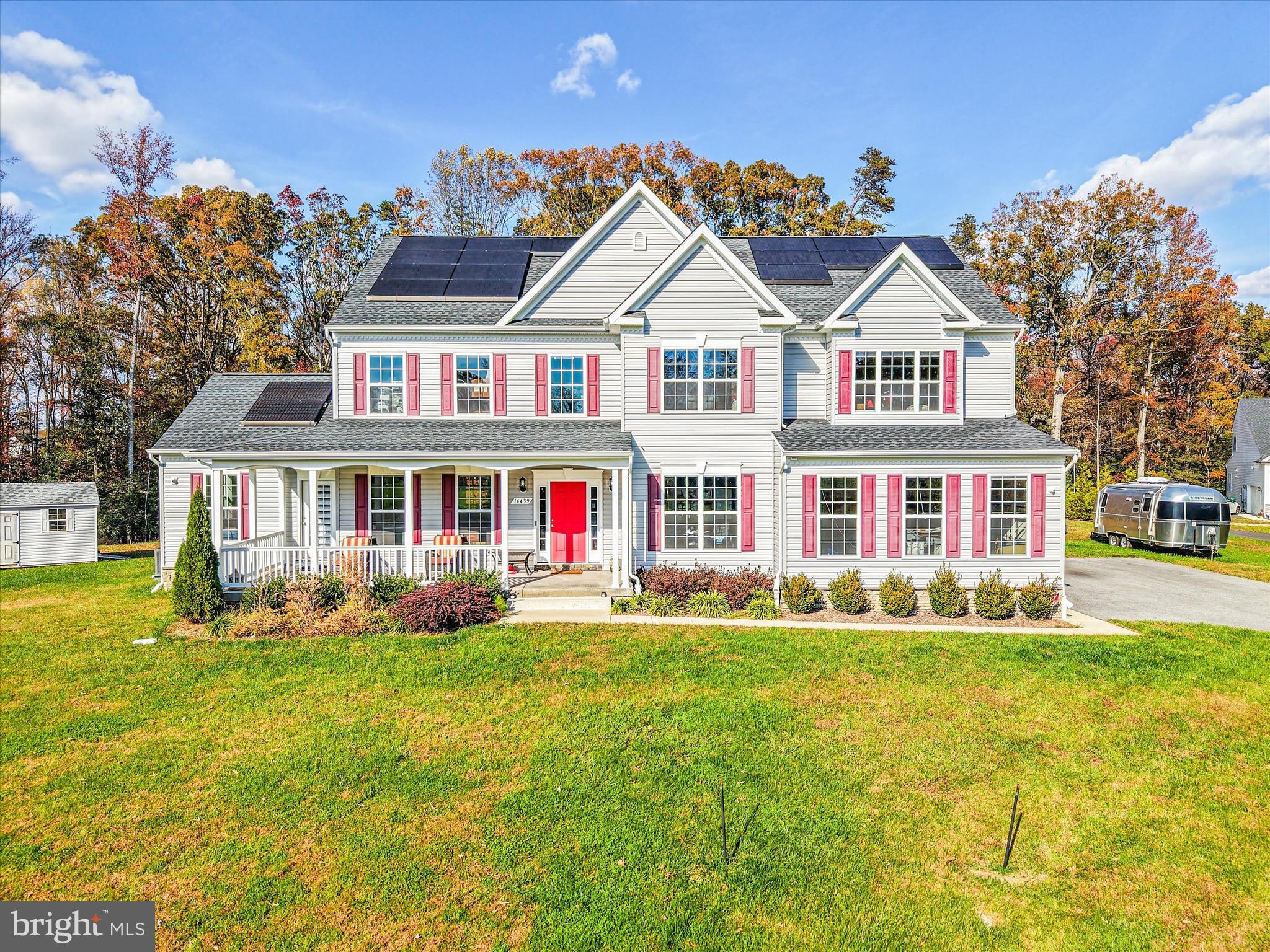 Nestled in the prestigious Ridge Grove Estates community, this custom-built Marrick Homes Augusta model offers 6,426 finished square feet of luxury living on 3.98 wooded acres that backs to a forest conservation. This contemporary Colonial blends timeless craftsmanship with modern comfort, showcasing 9-foot ceilings on the first floor, 8-foot ceilings on the second floor, expansive windows with built-in blinds, and designer finishes throughout.

The main level welcomes you with a grand two-story foyer and spacious layout ideal for entertaining. Enjoy formal living and dining areas with double tray ceilings, a private study with built-ins, and a stunning gourmet kitchen with granite countertops, an oversized island, pantry, smart home features, and adjoining morning room with cathedral ceilings. The family room features a gas fireplace with stone surround raised hearth and an alcove window with stone.  The conservatory has built-in speakers and displays lots of natural light.  

Upstairs, the owner’s suite boasts double deep tray ceilings with crown, two walk-in closets, and a spa-inspired owner’s bath with soaking tub, dual vanities, and dual head walk-in shower. The second and third bedrooms share a Jack-and-Jill bathroom while the fourth bedroom has it's own ensuite bathroom. The upper-level laundry room adds everyday convenience. Next to the laundry room is the door opening to the rough-in shaft for a future elevator.

The fully finished walkout basement extends your living space with a recreation room, exercise room, wet bar with granite counters, sink, wine cooler, cooktop, fifth bedroom, and a full bathroom.  The media room has tiered carpet flooring and is pre-wired for a projector, screen, and speakers.  This home contains a water filter and softener system that supplies the entire house, as well as a tankless water heater.     

Outdoors, unwind on the covered porch while enjoying lush trees and landscaping irrigated by 16-zone inground sprinklers. The side-entry two-car garage is equipped with an Electric Vehicle (EV) charger and 3 inverters for 46 solar panels. 

Every detail of this exceptional home reflects luxury, comfort, and tranquility minutes from commuter routes, schools, and local conveniences. Located in Hughesville, just a mile and a half from Route 5 in Southern Maryland, providing easy access for commuting to the DC metro area and airports. Enjoy shopping at nearby St. Charles Towne Center, Waldorf Marketplace or National Harbor. Local restaurants include a wide variety of world cuisines, and all types of dining atmospheres from casual to gourmet.  Outdoor activities abound at Gilbert Run Park, Indian Head Rail Trail, aquatic centers and sports fields.  Just in time for the holidays, this home can be yours!