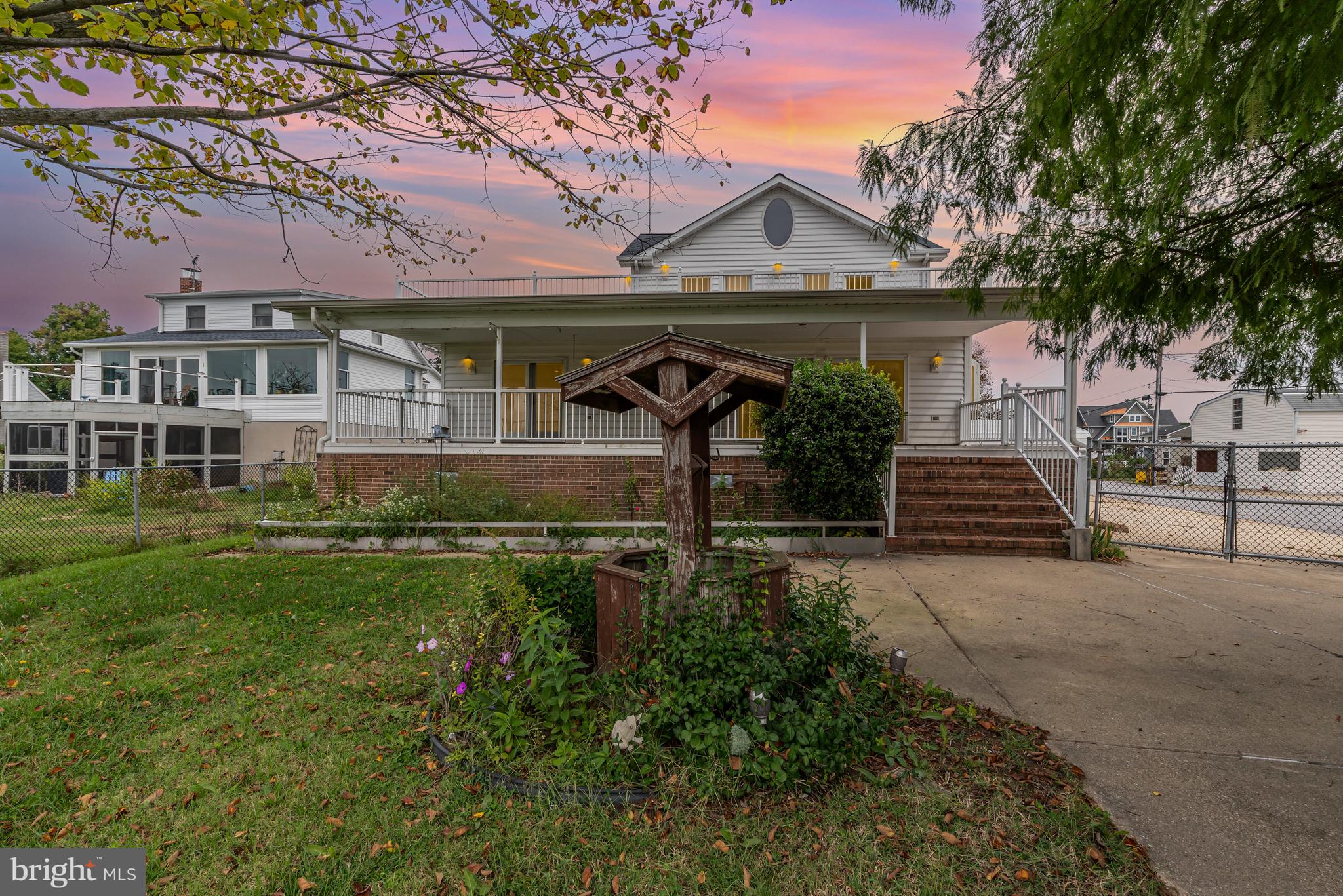 Discover one of the largest homes in the area with 2,288 sq ft above grade living space, offering endless potential to make it your own. This expansive 5 bedroom, 3 bath waterfront property boasts rare features you wont easily find elsewhere. On the main level, you'll find 2 bedrooms, 2 full baths, and a convenient laundry room, along with multiple access points to the stunning outdoor spaces. Two of the bedrooms open onto a wraparound deck through french doors, providing seamless indoor-outdoor living with breathtaking water views.  The properties waterfront amenities include a boathouse with a 150 ft electric boat lift at the end of a pier with approximately 6 to 7 ft water depth.  While the pier's electric service is currently non operational, the setup is already in place.  Car enthusiasts or hobbyists will appreciate the detached four car garage plus a carport, offering ample storage and parking.  A fenced in yard adds privacy and security. This is your chance to secure a true waterfront lifestyle.  Boat included with sale.  House, boat and pier are as is where is