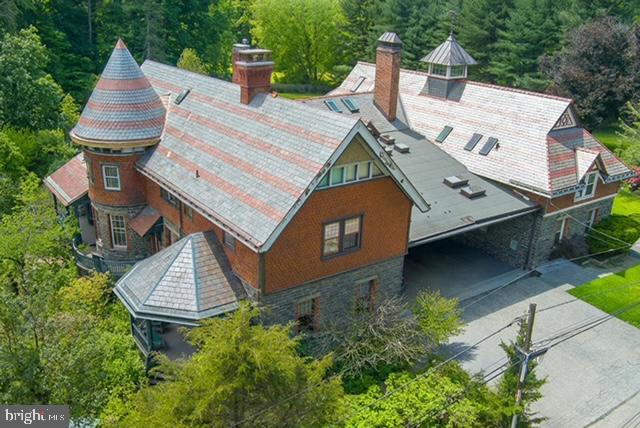 Approximately 4,630 square feet, five bedrooms, three and a half baths. Stone home built in 1889 as the original carriage house for the former Wentworth estate, now meticulously restored and situated on 0.88 acres in Bryn Mawr.

The owner has carefully restored key architectural elements, including a new slate roof, a second-floor turret, and custom curved windows to preserve the home's period integrity and craftsmanship. Nine rooms across two levels offer flexible living space, with three fireplaces adding character throughout.

Modern systems support contemporary living: EV-ready with a dedicated charger, electric heat, public water, a 400-amp electrical system, and on-site septic. Solar panels on the carport/loft roof reduce energy costs.  Secluded property surrounded by mature trees.  Small backyard pond, seasonal wildlife, and two rain gardens that manage storm water through underground conduit.

Located in Radnor Township and the Radnor school district, the home sits on a private drive with shared maintenance for paving and snow removal; the township handles trash collection.  Walkable to Garrett Hill dining and shops, with nearby train access for commuters.

Professional walk-through video available at:  https://youtu.be/oTqOHmHCTPg?is=h-Fq8VjcfP6NKLaX