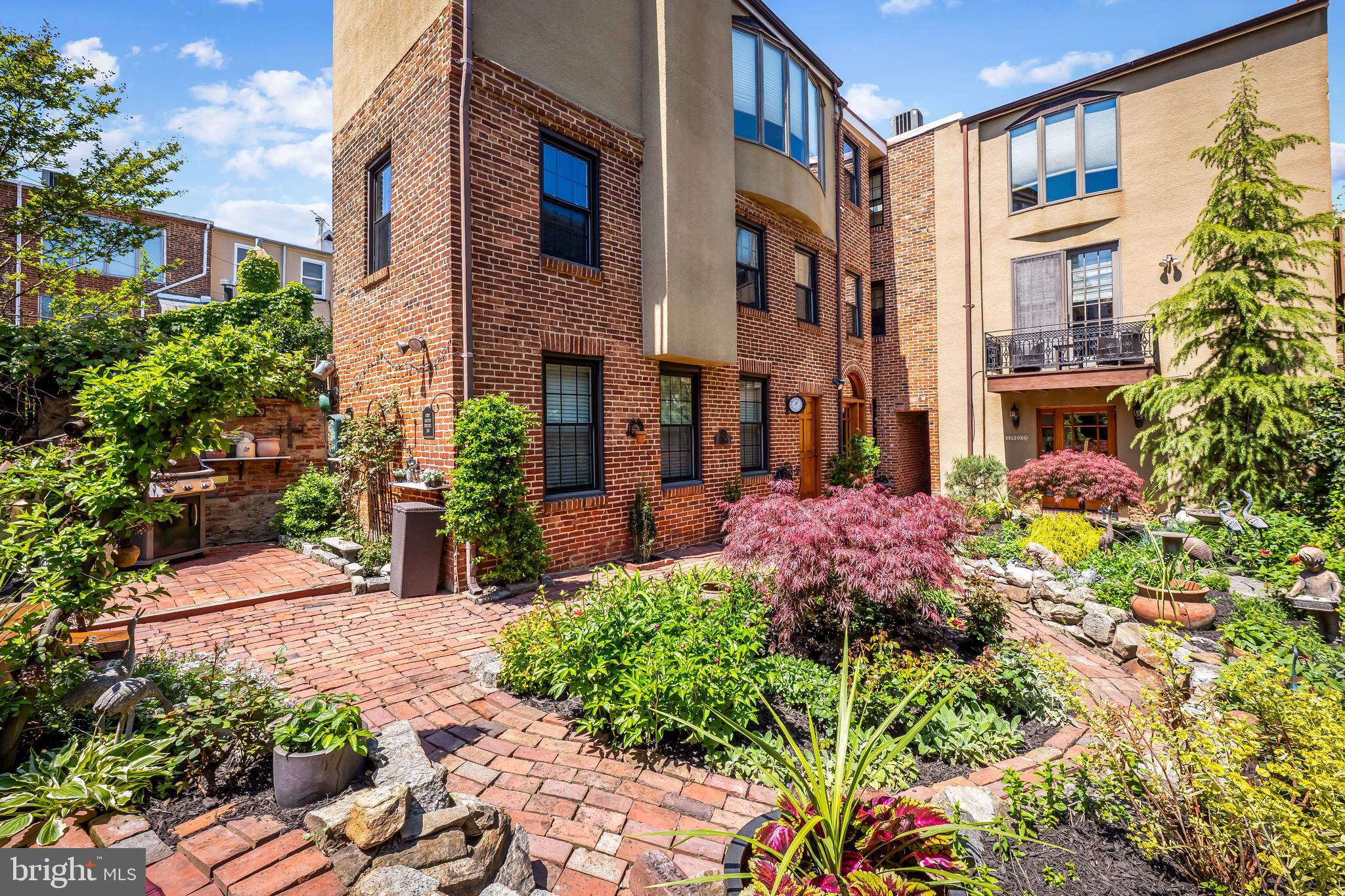 One of Fells Point’s Most Unique Homes Has Arrived. A Private Garden Residence in Fells Point. 36 Feet Wide. 2-Car Garage. Private Garden. Elevator. Unmatched. Welcome to 1807 Lancaster Street — a one-of-a-kind garden estate in the heart of Fells Point. Set on an exceptionally rare 36-foot-wide lot, this expansive 3,400+ square foot residence offers a scale and presence seldom found in the historic district. Behind its classic brick façade lies a thoughtfully expanded home featuring three levels of living, including a flexible first-level suite ideal for guests, an office, or in-law quarters. The main living level showcases a warm, inviting layout anchored by a spacious living room with a wood-burning fireplace, a formal dining room, a breakfast room overlooking the garden, and an updated kitchen with granite countertops and custom cabinetry. The upper level offers three well-proportioned bedrooms and a bath, including two walk-in closets with an abundance of storage space. What truly sets this home apart is the extraordinary 1,500 square foot private garden, a serene outdoor retreat rarely found in city living—perfect for entertaining, gardening, or quiet relaxation. Additional highlights include a two-car garage, newer windows, custom Spanish cedar doors, hardwood flooring, 3-story elevator, spiral staircase, and a stunning atrium with skylights pouring in natural light, along with architectural details that blend historic charm with functional space. Located just steps from the waterfront promenade, Harbor East, and some of Baltimore’s best dining and shopping, this is a rare opportunity to own a true single-family residence spanning two combined lots, offering a level of indoor and outdoor space rarely found in Fells Point.