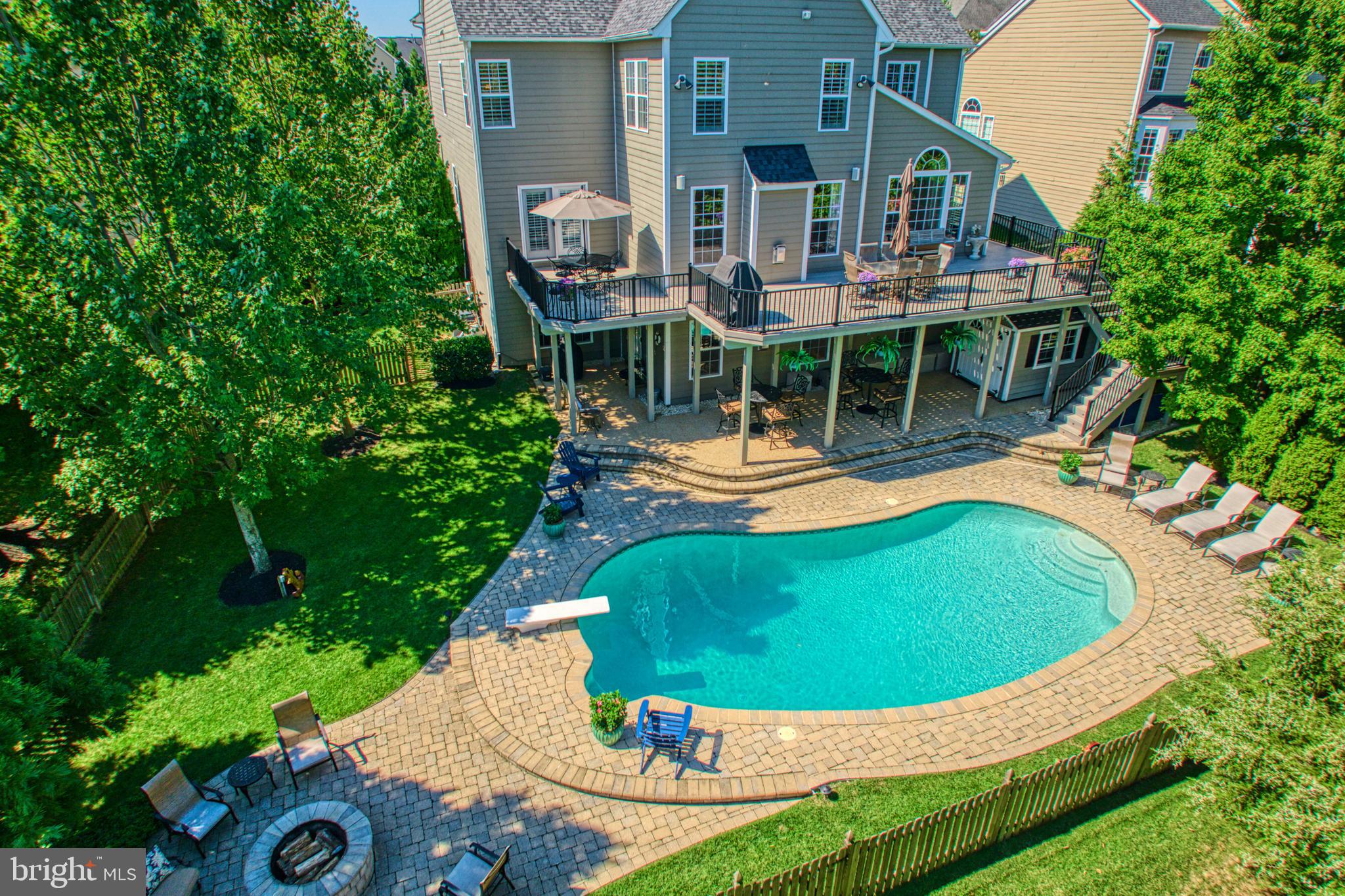 Fall in love with this stunning home in the sought-after Broadlands neighborhood of Ashburn. With 6 bedrooms, 5 ½ bathrooms, and nearly 6000 square feet of living space, it's perfect for family gatherings and entertainment. When you enter this home, the foyer leads to a magnificent staircase to the upper floor. You will also notice the lovely formal dining room, ready for dinner parties. There is also the living room, large enough for a grand piano and all your guests for an evening of music after dinner.  The heart of this home is undoubtedly the GORGEOUS fully renovated kitchen featuring substantial storage, beautiful quartz countertops, custom backsplash, glass cabinets, soft-close cabinets, and drawers, all with designer pulls, high-end kitchen appliances, and a wine fridge. Adjacent to the kitchen is the informal dining space with floor-to-ceiling windows. The main floor family room features a fireplace for cozy evenings. The main floor also features a massive deck with great views of the mature trees and overlooking the POOL. The heated saltwater pool is the centerpiece of an entertainer's dream backyard. It is surrounded by a large deck and patio, perfect for entertaining all your guests. A large stone patio is set back from the pool, available for additional seating. When you are finished for the day, retire to the upstairs and enjoy the owner's suite, which includes a big sitting area, two walk-in closets, and a luxurious spa-like bathroom. The renovated bathroom consists of a large shower and soaking tub. Four additional bedrooms, two with en suites, and another jack-and-jill bathroom complete the upper level. For more family activities, a fully finished lower level includes a sixth bedroom, another full bathroom, a recreation room with a fireplace, a theater/exercise room, and a storage room. This home also has a 2-car garage for when you need to leave. It is part of the Broadlands South HOA, which includes Broadband Internet, Trash and Recycling. The Broadlands community has multiple pools, tennis courts, a recreation center, basketball courts, tot lots, walking trails, and parks. Don't miss the chance to make this YOUR dream home!