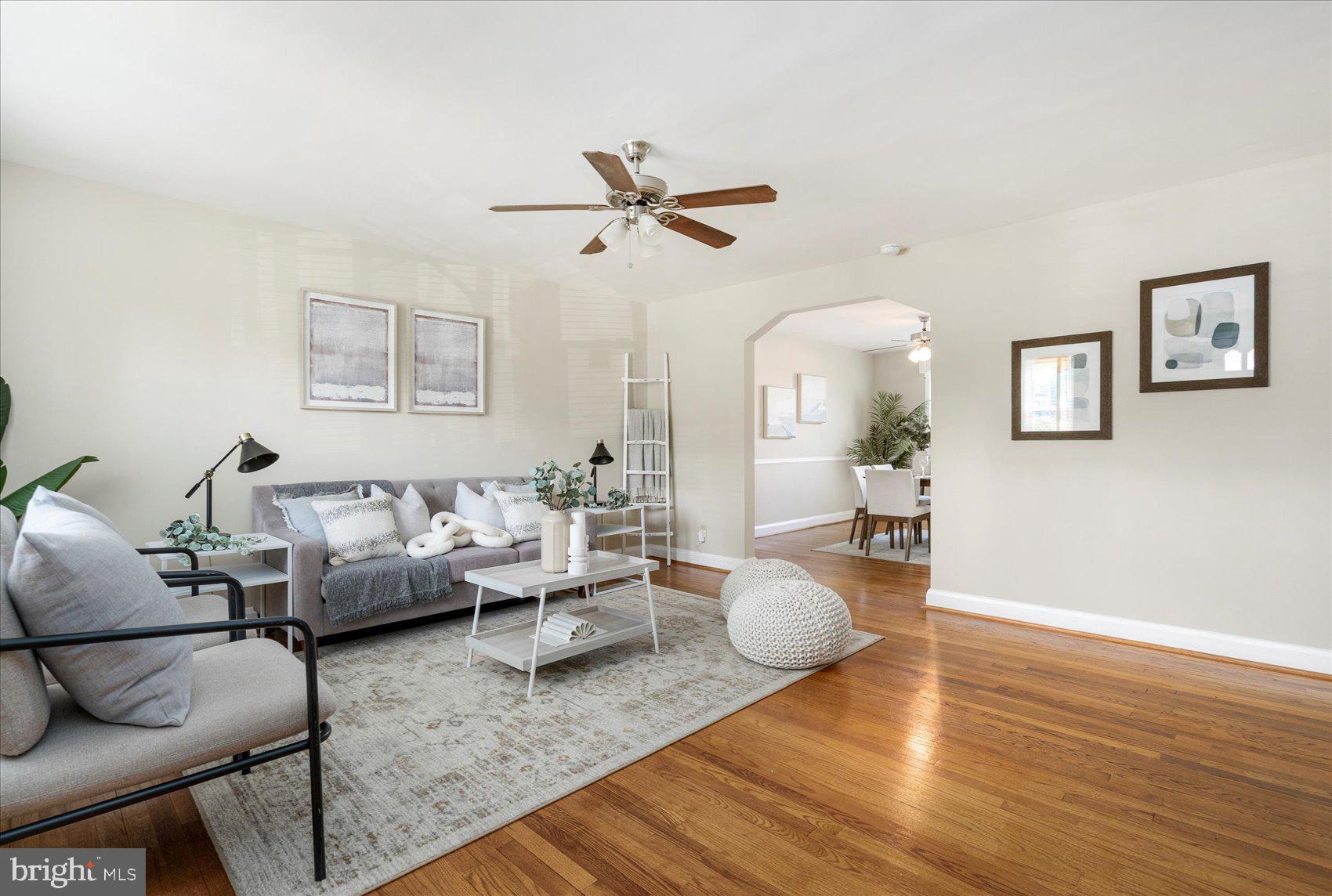 Beautifully refreshed 3BR/1.5BA brick Townhome located on a quiet street.  Walk past a lush lawn and a shade tree on your way to the front porch of your forever home.  Step into a home filled with tons of natural light, a soft color palette, and stunning hardwood floors on both the main and second floors.  The main floor offers a large living room with an arched entry into the dining room featuring chair railings, and the kitchen.  The kitchen is crisp and clean with newer appliances, and a large enamel sink.  On the second floor are two sizable secondary bedrooms, a spacious primary, and a classic black and white tiled full bath.  The lower level is finished offering additional living space with an open painted ceiling, a faux fireplace, a half bath, knotty pine paneling closets for storage, laundry hook up, and a walk-out to a covered patio in the fenced yard. From the kitchen step out onto a spacious balcony that overlooks a yard filled with green space and tons of possibilities.  This home is move-in ready with so much to offer new homeowners and is located in close proximity to shopping, restaurants, and commuter routes. ** Solar panels are paid for!**