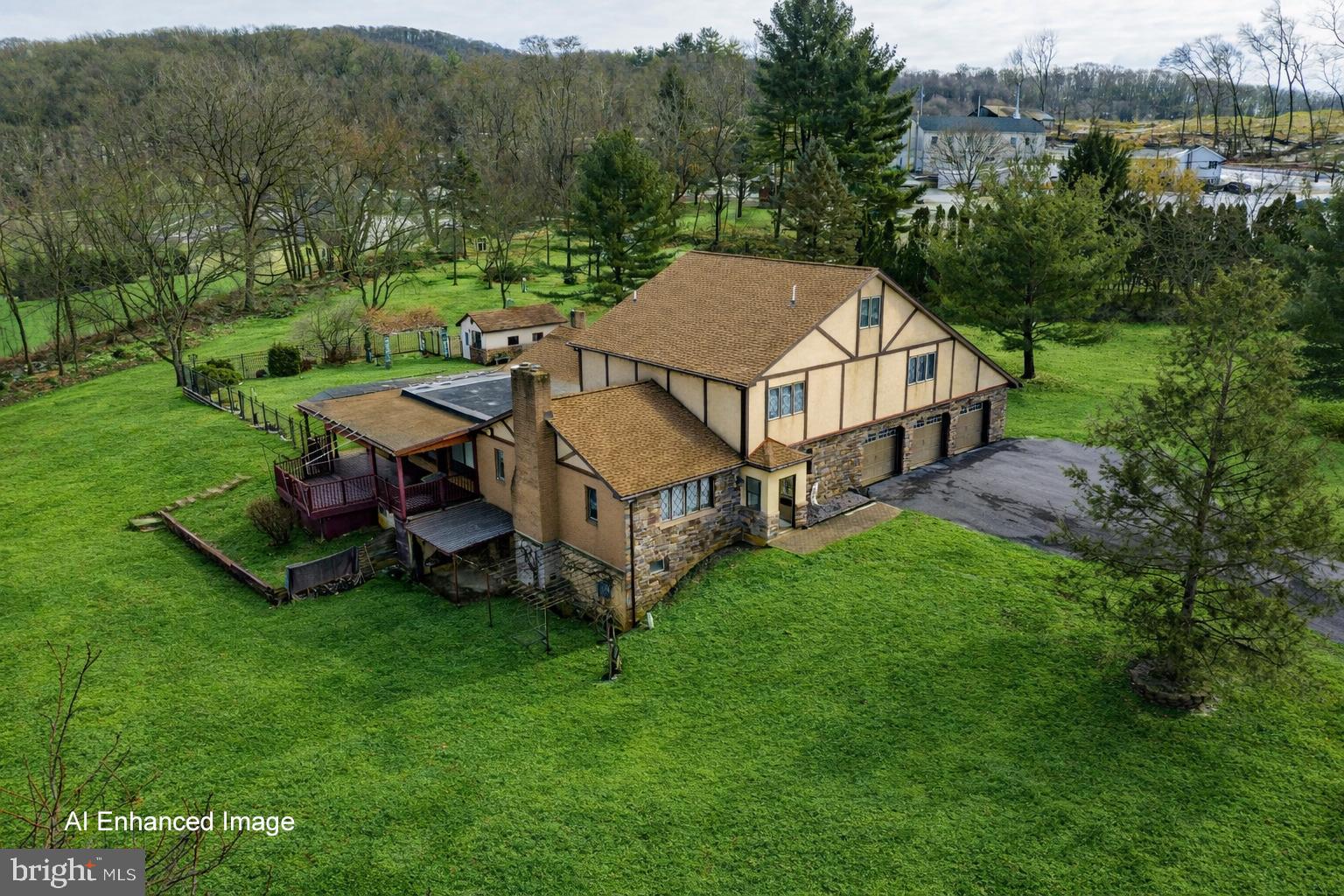 A UNIQUE OPPORTUNITY to own 6.71 ACRES in Hellertown Borough! Price includes an expansive colonial TUDOR-STYLE HOME of 6,335 SQ FT with INGROUND POOL & POOL HOUSE, a separate 2 UNIT RENTAL PROPERTY, & plenty of ACREAGE for POSSIBLE SUBDIVISION! The main CUSTOM BUILT, SINGLE OWNER HOME of 4-5 BEDROOMS and 4.5 BATHS is privately located via its own lengthy driveway surrounded by a buffer of mature landscape. Enjoy spacious luxury & QUALITY CONSTRUCTION featuring STAINED GLASS & SOLID PINE windows, doors, and cabinetry throughout. The 1st level includes a gourmet kitchen with CHERRY & GRANITE finishes, formal living room with fireplace, family room with deck access & SUNKEN 7 PERSON HOT TUB, DEN/OFFICE with ENSUITE FULL BATHROOM, 1st FLOOR PRIMARY BEDROOM SUITE with separate SITTING ROOM, private outdoor ENTRYWAY, and granite ensuite bathroom, plus a hall laundry room & half bath. Upstairs, a spacious hallway with large landing area leads to 3 bedrooms, a large storage room, & full bathroom. BONUS SEPARATE LIVING QUARTERS in the WALK-OUT LOWER LEVEL with 7.5 FT CEILINGS & its own SEPARATE ENTRANCE. FULL QUAKER-MADE KITCHEN, full bathroom with walk-in shower, large recreational rooms with fireplace, separate WORKSHOP ROOM with sink and more! 3 car ATTACHED OVERSIZED GARAGE+additional driveway parking for 15+ cars. 2 unit RENTAL PROPERTY is accessed via Easton Rd with its own driveway parking & storage structures! BOTH HOMES HAVE PUBLIC WATER & SEWER, GAS UTILITIES, & A CLEAR CO!