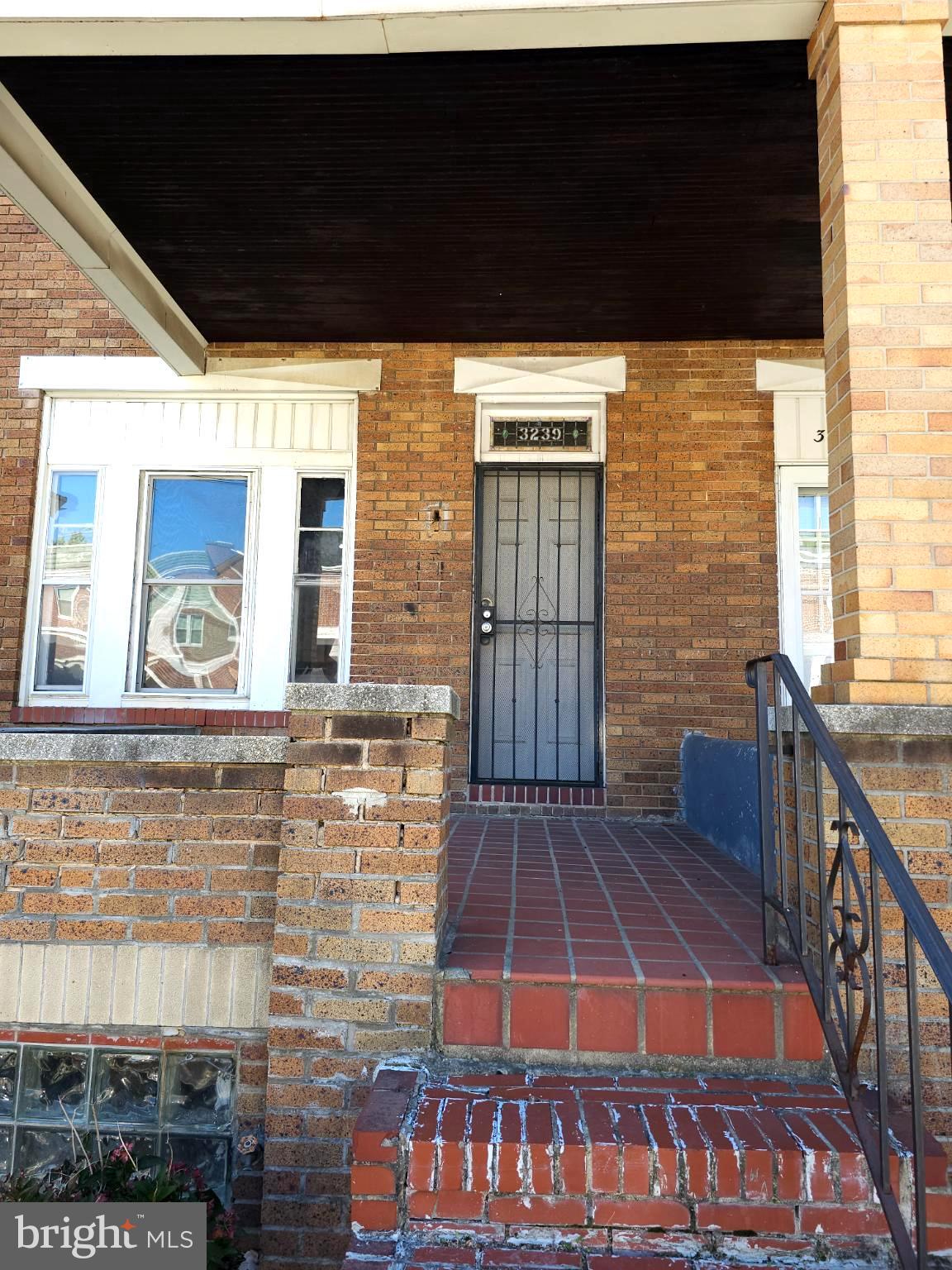 Spacious 1928 townhouse with high ceilings, open but separate main level rooms.  The kitchen has been cleared and is ready for your finishing touches.  Hardwood floors throughout.   Detached garage in back for off street parking or storage.