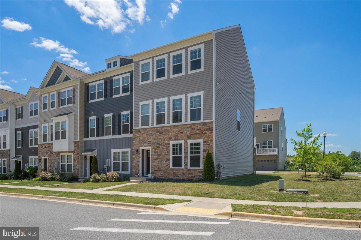 **ASSUMABLE FHA LOAN WITH 2.5% INTEREST RATE!**
Welcome to 2020 Hinshaw Drive — a beautifully maintained end-unit luxury townhome in one of Odenton’s most desirable communities. Only six years young and offering over 2,200 square feet of thoughtfully designed living space, this better-than-new home blends modern comfort, stylish upgrades, and everyday convenience.

Inside, you’ll find a bright and open 3-level layout with luxury vinyl plank flooring throughout the first two levels. The main living area is filled with natural light and flows seamlessly into the well-appointed kitchen, featuring quartz countertops, ample cabinetry, upgraded hardware, stainless steel appliances, contemporary light fixtures, and a breakfast area perfect for everyday dining or entertaining. A separate dining area and access to the large deck overlooking private green space complete this inviting main level.

Upstairs, the spacious bedroom level includes a beautiful primary suite with a private bath and walk-in closet, along with generously sized secondary bedrooms and a full laundry room for added convenience.

The lower level offers excellent flexibility with additional living space ideal for a recreation room, home office, gym, or guest area, plus interior access to the 2-car garage. Enjoy low-maintenance living, central A/C, and access to miles of community walking paths.

Ideally located near Fort Meade, BWI, MARC train access, shopping, dining, and major commuter routes, this home provides easy access to Annapolis, Baltimore, and Washington, DC. Modern, spacious, upgraded, and move-in ready — this exceptional Odenton townhome is truly a must-see.
