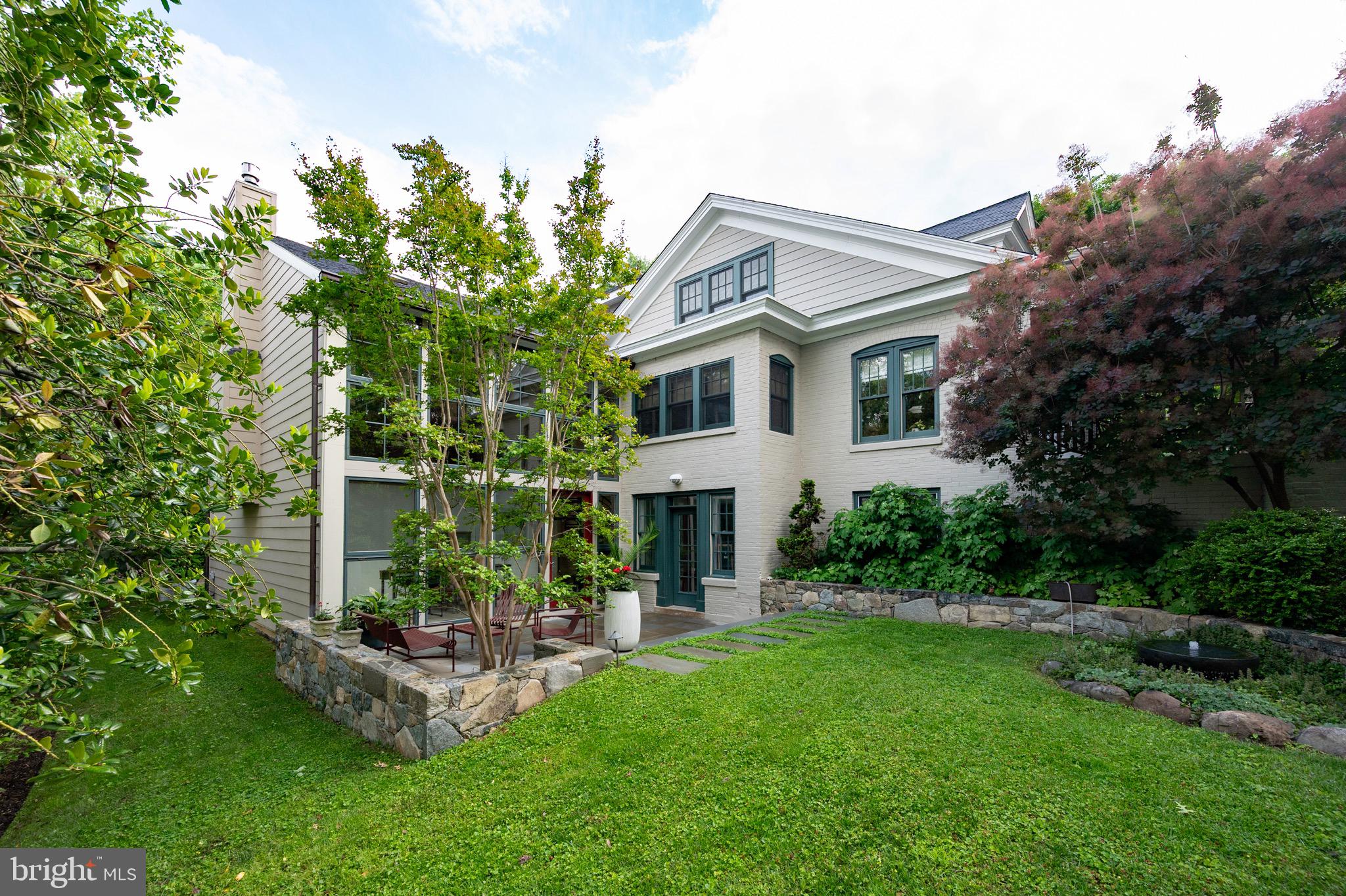 This historic home on an iconic Rosemont street is one of the premier properties in the neighborhood. With extensive additions and high-quality remodeling throughout, it is the perfect blend of traditional and modern charm. A wide front porch offers the perfect spot to relax and enjoy the meticulously maintained, mature landscape. Upon entry, a spacious open foyer greets you with two coat closets and custom built-ins, leading into a light-filled living room with walls of historically preserved windows, skylights, and a cozy fireplace. Just off the living room, a charming library invites quiet reading or a thoughtful game of chess, while a separate home office features two built-in desks and bookshelves—ideal for working from home.

The formal dining room adds a classic touch, but the real showstopper is the stunning addition that nearly doubles the size of the house. With a soaring two-story wall of windows, vaulted ceilings, and a high-end open kitchen featuring custom cabinetry, top-tier appliances, and an eat-in area, this space is truly the heart of the home. The adjoining family room centers around a striking custom fireplace wall. A spiral staircase leads to a unique studio space that opens to a private outdoor patio, complete with a tranquil water feature that attracts local birds.

Upstairs, three bedrooms await, including a luxurious primary suite with dual walk-in closets and a spa-like bathroom featuring custom tile and heated floor and towel rack. The second and third bedrooms maintain the home’s original charm with built-ins and cozy reading nooks, and they share a second full bath with a tub. The lower level offers a spacious in-law suite with a private entrance from the patio, a third full bathroom with a shower, ample storage, and a dedicated laundry room.

The exquisite yard has been professionally landscaped and curated with extensive hardscaping, mature plantings, and a full sprinkler system. A two-car garage with rear entry and solar panels complete this remarkable property. Every detail of this home has been thoughtfully designed to blend timeless charm with modern luxury.

Conveniently located just blocks to two metros,  Amtrak, Del Ray, Old Town, and minutes to the Pentagon and Washington DC.
