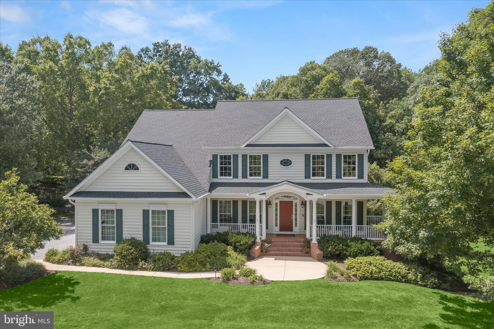 Welcome to the prestigious Benson Mill community of Finksburg, where over two-and-a-half acres of impeccably landscaped grounds create a private estate setting defined by elegance, comfort, and timeless craftsmanship. This stately colonial, highlighted by a charming wraparound front porch, offers a traditional floor plan thoughtfully designed for luxurious living and exceptional entertaining.  Step into the grand foyer and be greeted by exquisite architectural details including crown molding, box wainscoting, a transom Palladian window, and gleaming hardwood floors that continue throughout much of the residence. The formal living room is bathed in natural light from floor-to-ceiling windows and provides the perfect setting for enjoying the picturesque surroundings. Designed to impress, the formal dining room showcases crown molding, chair rail accents, box wainscoting, and in-wall speakers, creating an elevated atmosphere for memorable gatherings.  The gourmet kitchen is both beautiful and functional, featuring granite countertops, a stone ceramic tile backsplash, stainless steel appliances, 42-inch cabinetry with convenient pull-out drawers, and a spacious pantry. Adjacent living spaces include a private office ideal for remote work or an additional bedroom, a powder room, and a thoughtfully designed mudroom with laundry facilities and direct access to the oversized three-car garage.  Retreat to the luxurious primary suite through elegant French doors and discover a sanctuary enhanced by hardwood flooring, custom blinds, and a soaring cathedral ceiling. The spa-inspired en-suite bath features a relaxing soaking tub, glass-enclosed walk-in shower, separate vanities, a private water closet, and direct access to a spacious walk-in closet complete with custom organization systems. Three additional generously sized bedrooms provide exceptional accommodations, each with hardwood flooring, including two connected by a shared bath and one offering a private en-suite bath.  The fully finished lower level presents endless possibilities for recreation and relaxation, featuring plush carpeting, a game area, exercise room, lounge space, recreation room, and abundant storage.  Outdoor living reaches new heights in the spectacular backyard oasis. A covered porch with storage underneath overlooks the tranquil landscape and flows seamlessly to a custom fire pit area. A private brook originating near the upper patio meanders through the property, enhancing the serene atmosphere. Additional amenities include a bocce court or putting green, a mini driving range, garden space, a lacrosse wall, a two-story playset with electrical, and private, deeded access to Liberty Reservoir Watershed with scenic walking and biking paths, hiking, and fishing.  Perfectly positioned for both privacy and convenience, the home offers easy access to I-795, MD-91, and MD-32, providing seamless travel to BWI Airport,  Baltimore’s Inner Harbor, the monuments and museums of Washington, D.C., and a wealth of shopping, dining, and entertainment destinations.  Updates: Roof, Putting Green/Bocce Area, Heat Pump, Water Heater, 3mm Window Film.