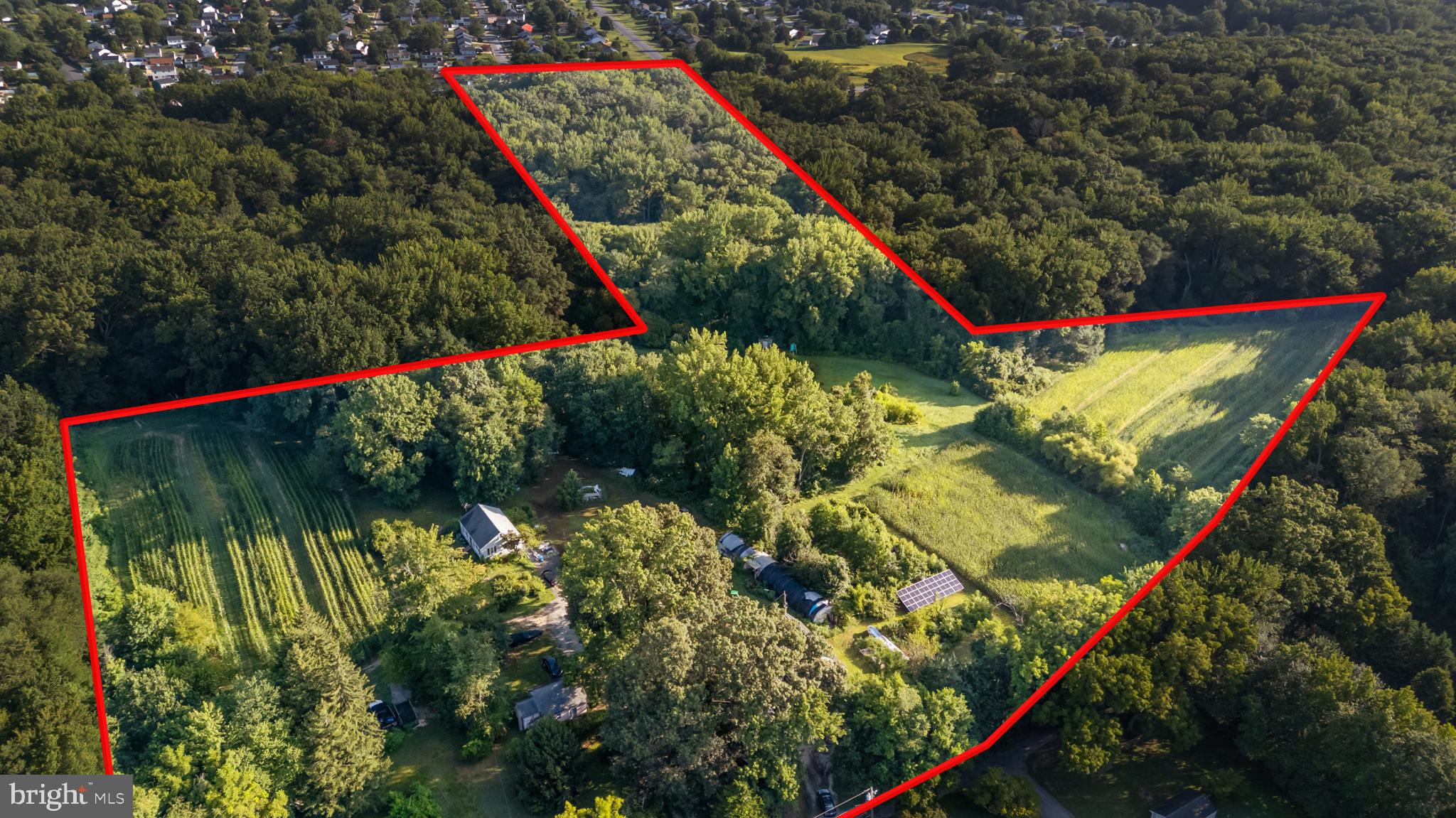 This listing is brimming with potential. Nearly 20 acres in the serene countryside of Bear, DE, this mixed use property offers a perfect blend of tranquility and convenience. Middletown and Newark, DE, including the University of Delaware; Cecil County (Elkton, MD); Kent County, and even Delaware beaches are accessible. Located just minutes from major highways (I-95, Rte 1, Rte 7, Rte 40 and Rte 896), shopping centers, and schools, it offers the ideal location for both privacy and accessibility. Reach the Philadelphia International airport within an hour and BWI airport in MD under 2 hours. Explore the possibilities of building your own home(s), a small subdivision, or restart a farm, etc. Three parcels are sold together with all existing homes included in the sale. Option to allow a paintball company to operate as an agricultural tourism use.
