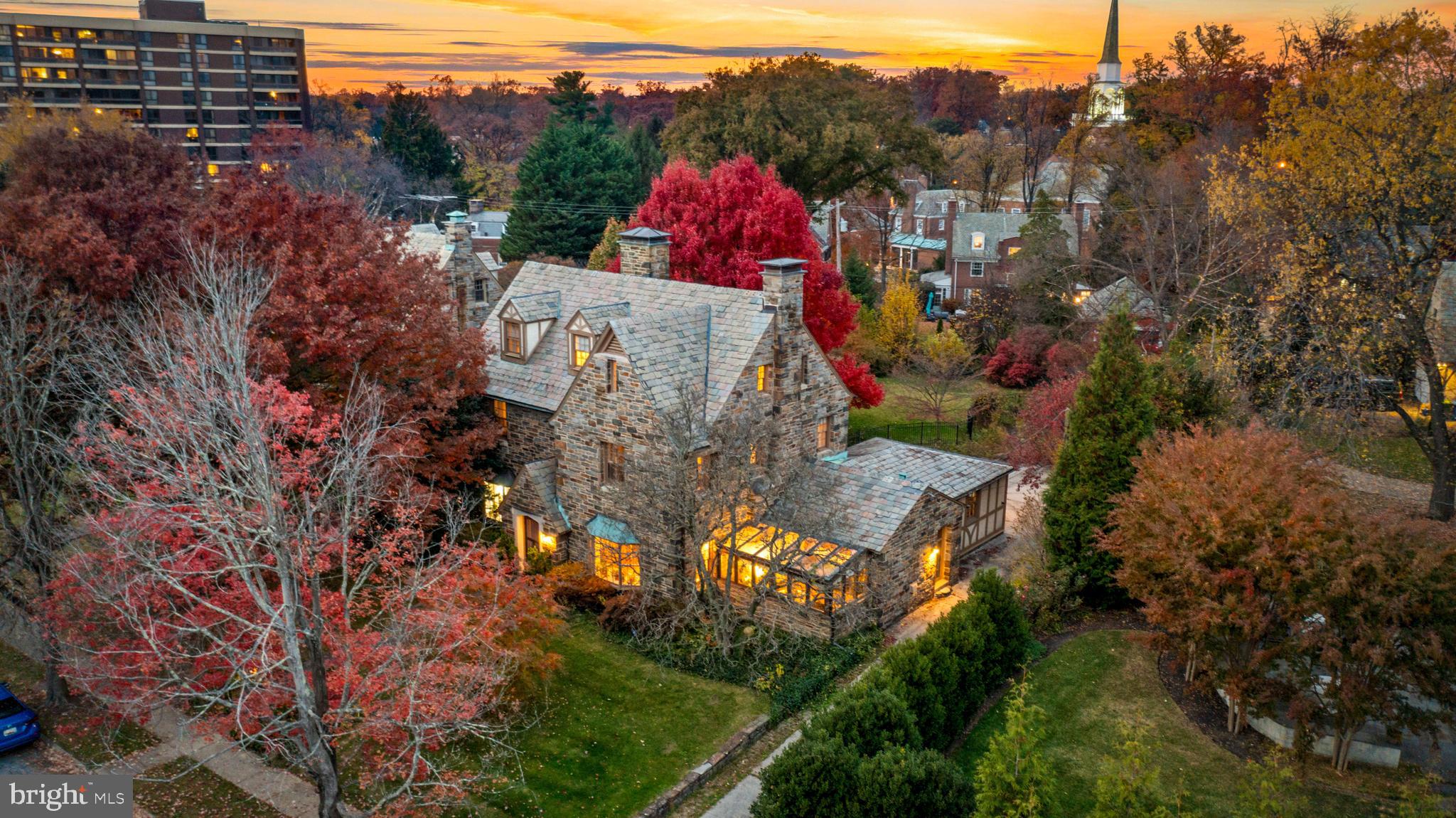 Happy holidays from 6 E. Highfield! This special home has been in the same family for nearly 100 years and is finally making its debut to find new residents to cherish it for the next 100. This 1920s all-stone house has the great old bones only found in early 1900s built houses. It's adorned with irreplicable historic details that will satisfy the wants of any architectural purist, yet it boasts an amazingly functional floorplan that lends itself to anyone looking to enhance it with more modern finishes. With an effortless flow and well-proportioned room sizes, there are 5-6 bedrooms, 3.5+ bathrooms, approximately 3,750 sqft above grade, and an additional 1,860 below, making it roughly 5,600 sqft in total. There are 6 fireplaces, each unique in detail, staggered wide plank hardwood floors, and handsome moldings throughout. The kitchen is extremely cool, with ample cabinetry and a large center island that opens to a solarium with walls and ceilings of glass. You’ll find yourself with a consistent topic of conversation when hosting. Directly off the kitchen is a bonus room that would make a perfect combination of a butler's pantry and mudroom. The formal living room and dining rooms are beautiful traditional spaces, each with bay windows and wood burning fireplaces. There is also additional space behind the living room that would make a great home office. The lot is amazing - .35 flat, open acres, mostly fenced, providing the perfect setting for summers full of children’s laughter, lively barbecues with friends, beautiful gardens, and tranquil dinners under the night sky. For anyone looking to add a pool, rejoice - there’s room for one here! To enhance the outdoors even more, there is a flagstone patio, a pond, a charming covered porch with electricity, and incredible specimen trees scattered about. There is also a convenient 2-car garage attached to the rear of the home. Travel back inside to the 2nd floor, and you'll find two ample-sized bedrooms and a full bathroom, as well as a large primary suite. The primary suite is oversized with an updated en-suite bathroom, dual closets, and a fireplace. The 3rd floor of the home has two additional bedrooms, another full bathroom, and a large storage room that could be easily converted into a 6th bedroom. The basement is currently partially finished but has tremendous potential if you find yourself needing more living space. It's 1,800 sqft with tall ceilings, a partially finished bathroom, and most of the basement has been waterproofed . There is also a one-of-a-kind antique bar that was salvaged from a restaurant in Fells Point long ago. You’ll be hard-pressed to find a more amenable house than this in Guilford at this price point. It offers a wide variety of options, whether you’re an architectural purist who wants to lean into the rich historic details that exist or someone who wants to upgrade and enhance what already exists by adding more modern finishes, the house fits either perspective. In addition to all that, this home uniquely falls into the Roland Park Elementary-Middle School district and is also walkable to Calvert School, ensuring excellent schooling options for families. Guilford is the perfect neighborhood for anyone looking for a detached home with a yard but who doesn’t want to give up the social amenities offered by city living. In Guilford, you can find the space and privacy you need, but you’ll still have neighbors to spend time with, restaurants to walk to, museums to visit, and parks to convene in. Additionally, the HOA will keep you engaged with neighborhood events and parties throughout the year. Guilford is also located centrally between downtown Baltimore and Baltimore County, making commuting to either convenient. It’s also minutes from major employers like Johns Hopkins, Loyola, and Union Memorial. This is your opportunity to secure this special Guilford house as your family's beloved holiday home for years to come. Don't miss it!