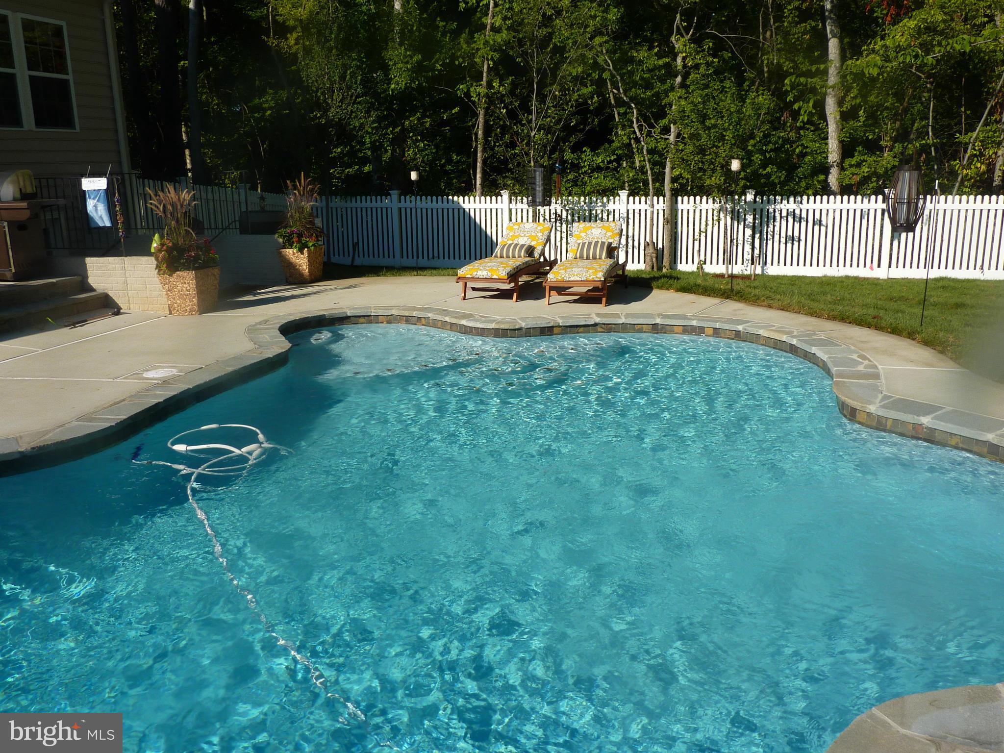 Almost 4,000 finished sq. feet in this 4 yr. old home  Enjoy low maintenance Salt Water Heated Swimming Pool and vacation at home in your own back yard backyard. Trex deck, custom stone patio, LED lighting, vinyl fence, sprinkler system. Gourmet kitchen w/stainless appliances.,granite counters, sun room/breakfast area. Upstairs sitting room/loft.