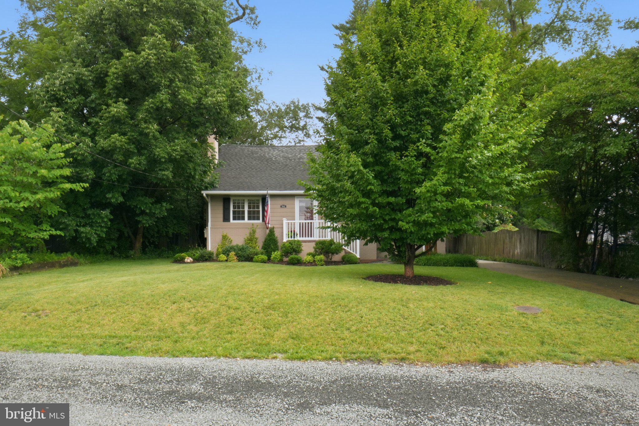 Join us for an open house on Friday, June 26th, from 5-7 pm, Saturday, June 27th, from 1-3 pm, and Sunday, June 28th, from 2-4 pm. Welcome to 7002 Lee Park Court, a charming Cape Cod offering 4 bedrooms, 2 full bathrooms, and a spacious quarter-acre lot. Nestled among mature trees on a quiet street, this home offers a peaceful setting while remaining just moments from the dining, shopping, parks, and entertainment that Falls Church has to offer.

Step inside to an inviting living room centered around a classic wood-burning fireplace, creating a warm and welcoming gathering space. The dining room overlooks the backyard, while the updated kitchen offers ample cabinet and counter space and connects to a cozy breakfast nook perfect for casual meals. The main level features two spacious bedrooms, a full bathroom, and multiple storage areas for added convenience.

Upstairs, you'll find a generously sized primary bedroom complete with ample closet space and built-in lighting. Down the hall is the fourth bedroom, conveniently situated adjacent to a dedicated laundry room that could easily be enclosed for additional privacy. A second full bathroom features a walk-in tiled shower. Storage is abundant throughout the upper level, including attic space accessible from both the hallway and the primary bedroom. Additional storage can be found in the large closet beneath the staircase on the lower level.

The outdoor living is equally impressive and rarely found in Falls Church. Step onto the spacious deck overlooking the level quarter-acre lot, offering endless opportunities for entertaining, outdoor dining, gardening, play, and summer gatherings. The oversized driveway comfortably accommodates three or more vehicles, with additional street parking available for guests.

Enjoy an unbeatable location just minutes from the Mosaic District, Downtown Falls Church City, Tysons Corner, and both the East and West Falls Church Metro stations. Holmes Run Valley Park is just a short stroll away, providing scenic trails and peaceful morning walks, while Routes 50, 66, 495, and 395 offer easy access throughout the region.

Recent updates include a new HVAC system (2023), crawl space insulation (2023), updated lighting and fixtures (2024), a new refrigerator (2022), new rear siding and gutters with a transferable lifetime warranty (2026), a new water heater (2026), a refinished deck with fresh paint and sealant (2026), and professional landscaping improvements (2026).