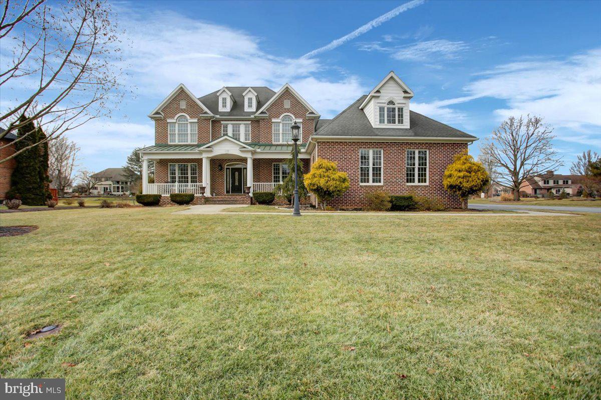Nestled on a well-manicured half-acre corner lot, this stunning custom built 2.5-story transitional home offers an inviting blend of traditional charm and modern amenities. Boasting an oversized 2-car garage with 700 square feet of space, as you approach the front door you are welcomed by a enviting covered porch flanked by landscaping. 

Step down into the great room and be awed by the 20-foot high ceilings and a wall of windows that flood the space with natural light. The focal point is an all-brick gas fireplace, complete with a brick sitting area, perfect for cozy gatherings. Hardwood floors grace the entire first floor, creating a warm and elegant ambiance.

Adjacent to the great room, the sunken living room is separated by stately columns, adding a touch of grandeur. The fully updated kitchen  features a double wall oven, French style refrigerator, built in microwave, corner built in cook top area with a custom-made noodle board, farmhouse style double bowl sink. Newer oversized subway tile backsplash and granite countertops, and a new custom built island for additional prep space. The dining area offers  enough space for a countertop-height kitchen table that comfortably seats eight,  If you love to entertain, the home offers a formal dining  room, perfect for gatherings. 
 The welcome home hub off the garage is a spacious mudroom and laundry area designed for effortless organization and comfort.
The first-floor ensuite is a private retreat with a walk-in closet and a spa-like bathroom, complete with a fully tiled walk-in shower, large soaking tub, expansive vanity with makeup area,  and storage,

The U-shaped open staircase leads to the upper level, which offers three additional large bedrooms—two with vaulted ceilings and all equipped with ceiling fans. At the end of the hall, a versatile bonus room provides ample additional living space, a walk-in closet, and a large unfinished walk-in storage area. Need even more storage? No worries! There's a walk-up attic boasting 525 square feet of storage space.

Just shy of 3,600 square feet, this home is looking for a new owner. Could it be you? Don't miss the opportunity to make this masterpiece of design and functionality yours!