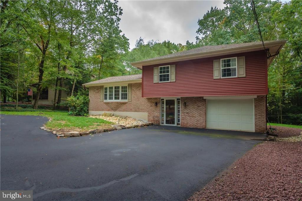 Location Location Location!  Welcome to Lake Hauto PA!  This 3 bedroom, 1.5 bathroom split level with private lot is located within a short walking distance to the beach!  If you're looking for a vacation home or a forever home - you will find it here at the Lake!  Sandy Beaches, Club House, Tennis Courts, gated Community and much more!  No wasted space here - upper level family room with large bay window, dining area, semi finished kitchen waiting for your finishing touches.  Updated full bathroom in addition to 3 nice sized bedrooms and plenty of closet space.  Lower level offers large family room with propane fireplace, half bathroom, enclosed rear patio overlooking your private backyard.  SECURITY SYSTEM.  1 car attached garage with laundry area.  Outdoors offer large rear deck, enclosed rear patio, circular macadam driveway, outdoor utility shed and private yard.  Located just one block walk to the Beach!  Add your own ideas and finishing touches and make this Beach home your own!  1 YEAR HOME WARRANTY INCLUDED!  Call today for your private showing!