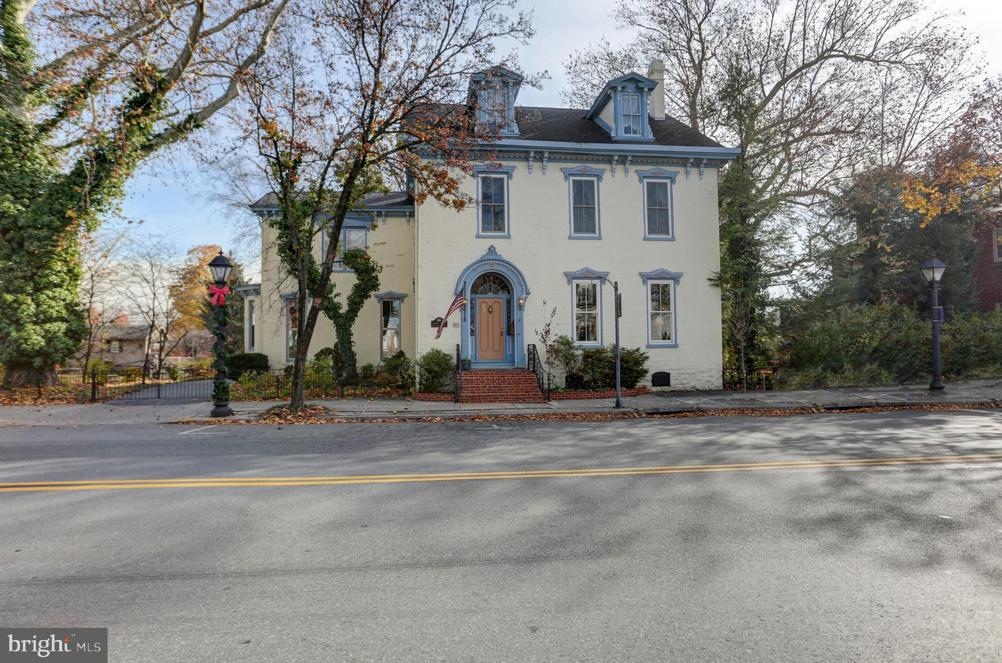Announcing the historic brick Victorian McLean House built in 1798. Take a trip back in time as you enter the expansive grand foyer showcasing high ceilings with elegant crown molding details while boasting one of two gorgeous winding staircases and beautiful new custom windows surrounded by original folding wooden shutters throughout. She has been lovingly cared for and was most recently known as the McLean House Bed 'n Breakfast, boasting two impressive front parlor rooms with a timeless gas fireplace, a gorgeous dining room with a marble gas fireplace and its own show-stopping staircase, 6 spacious bedrooms, 5 full baths and just under 5,000 square feet of priceless character on a little over a half-acre of private secret garden settings. You might overlook the hideaway rear garden featuring a private in-ground swimming pool and patio area and red storage barn. This home was one of the first in the area to install interior gas lighting which has been converted to electric. The popularly photographed storybook carriage house sits on the edge of the Middle Spring creek and was once used as a summer kitchen with an original fireplace in the front and a horse stable towards the rear which is now a one car garage. Many updates have been made and many possibilities abound for this heirloom property located in downtown Shippensburg, PA and across from the town Library. The zoning status is Neighborhood Commercial and is in a flood zone due to the creek, flood insurance will be required for a mortgage. Cash or conventional only offers will be considered, no government loans. Please note that security cameras are on-site. Furnishings may be negotiable for sale separately. Don't miss this rare opportunity to own a stunning piece of history!