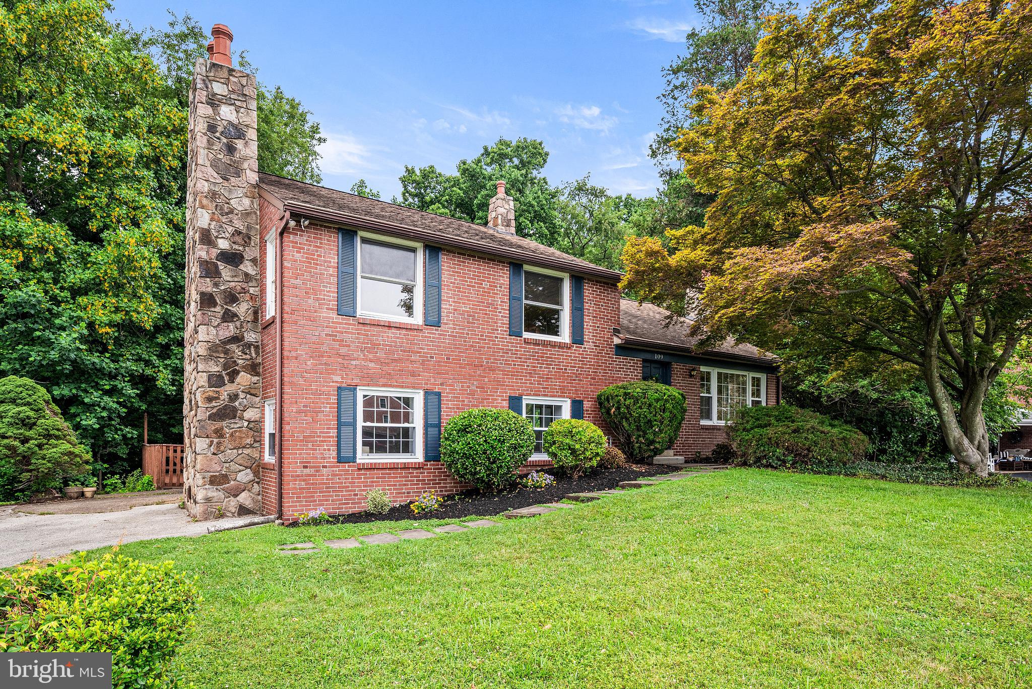 This classic brick split-level in the sought-after Wallingford-Swarthmore School District offers a sophisticated blend of versatile living spaces and incredible outdoor entertaining. From the moment you step onto the main level, you’re greeted by original hardwoods and a seamless flow between the living and dining areas. The kitchen has been totally updated with brand new appliances, crisp white cabinetry, timeless tile backsplash, and sleek new countertops—all framed by windows that invite the outside in.

A true showstopper is the expansive, 900-square-foot Trex deck. Recently resurfaced for low-maintenance luxury, this massive outdoor living space overlooks a lush, wooded backdrop, providing a serene and private sanctuary. Adjacent, the large level yard features a substantial shed perfect for a workshop or organized storage.

Versatility defines the lower level with its own private entrance from the driveway. It boasts a large bedroom (can alternately be an office, playroom, den) and features a cozy gas fireplace and excellent closets. This level has a large full bath with laundry, and a sitting area with a kitchenette- also great as a wet bar or coffee station- and a slider to the deck. All windows on the lower level and first floor are brand new. This space is a rare find! Whether utilized as a home office, an au pair or guest space, the possibilities are numerous.

The upper levels continue to impress with three bright bedrooms, including a primary bedroom anchored by its own wood-burning fireplace. The sizable hall bath includes a double vanity and a large walk-in shower featuring dual shower heads. The floored, walk-up attic and unfinished basement offer incredible storage or the potential for future customization.

Life in Sproul Estates means being part of a vibrant, connected community. Enjoy easy access to the cute playground and ball field just down the street, or take advantage of the seamless commute to Philadelphia and Wilmington via nearby 476, I-95, or the SEPTA line. With the eclectic dining, boutique shopping, and cultural hubs of both Media and Swarthmore just minutes away, this home puts the very best of the region right at your doorstep.
