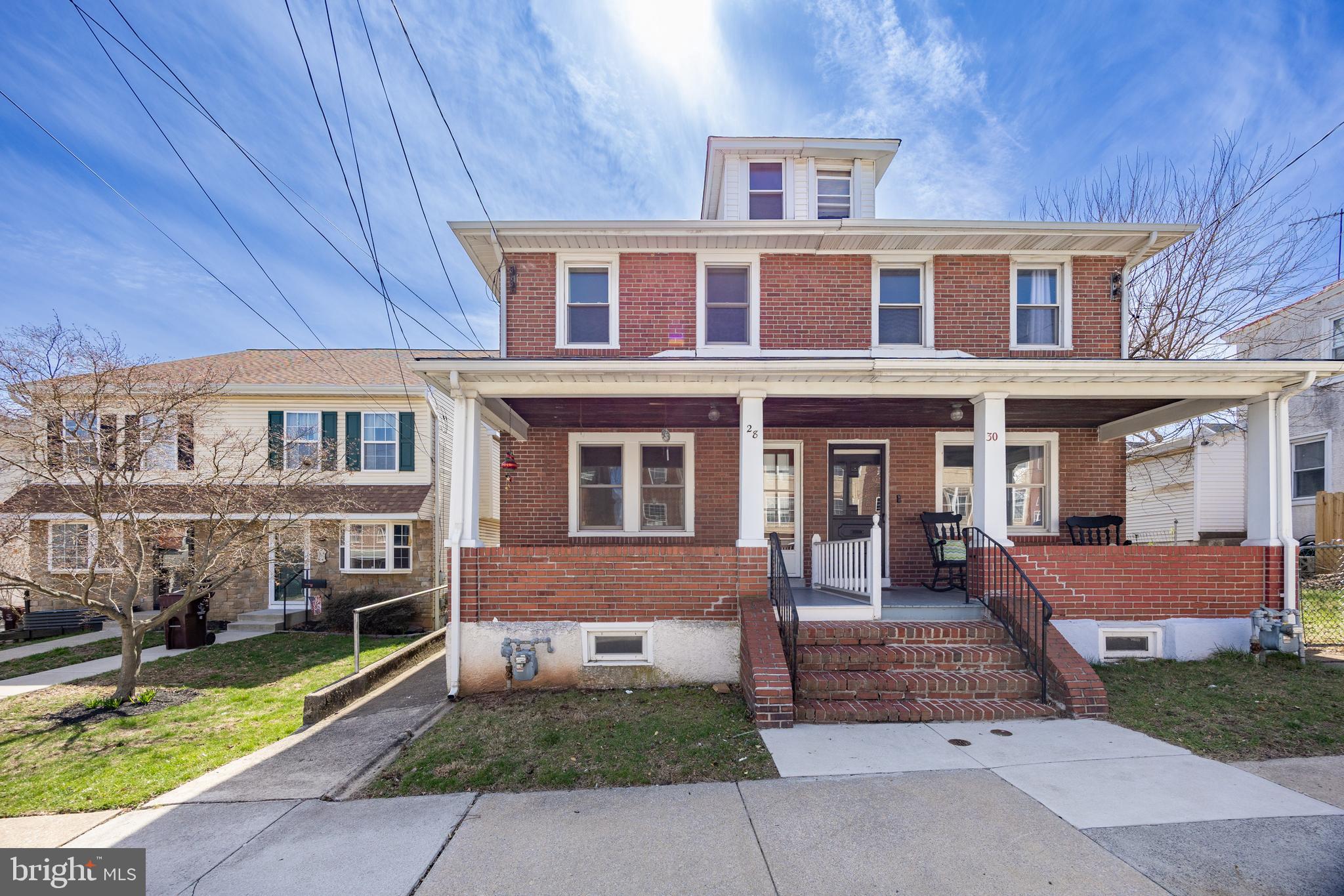 Solid Brick Twin in Bridgeport Borough with Off-Street Parking for Two Cars! This charming home features an inviting covered front porch, a spacious living room and dining room with hardwood floors beneath the carpet, and an updated eat-in kitchen with granite countertops, a tile floor and backsplash, a dishwasher, a gas range, and a built-in microwave. A convenient powder room and access to the rear yard complete the first floor. Upstairs, you'll find three generously sized bedrooms, all with ceiling fans, a tiled hall bath, and a walk-up attic with flooring for extra storage. The full basement includes a washer and dryer and a rear yard access door. Recent updates include a new roof (August 2020) and a new hot water heater (2017).