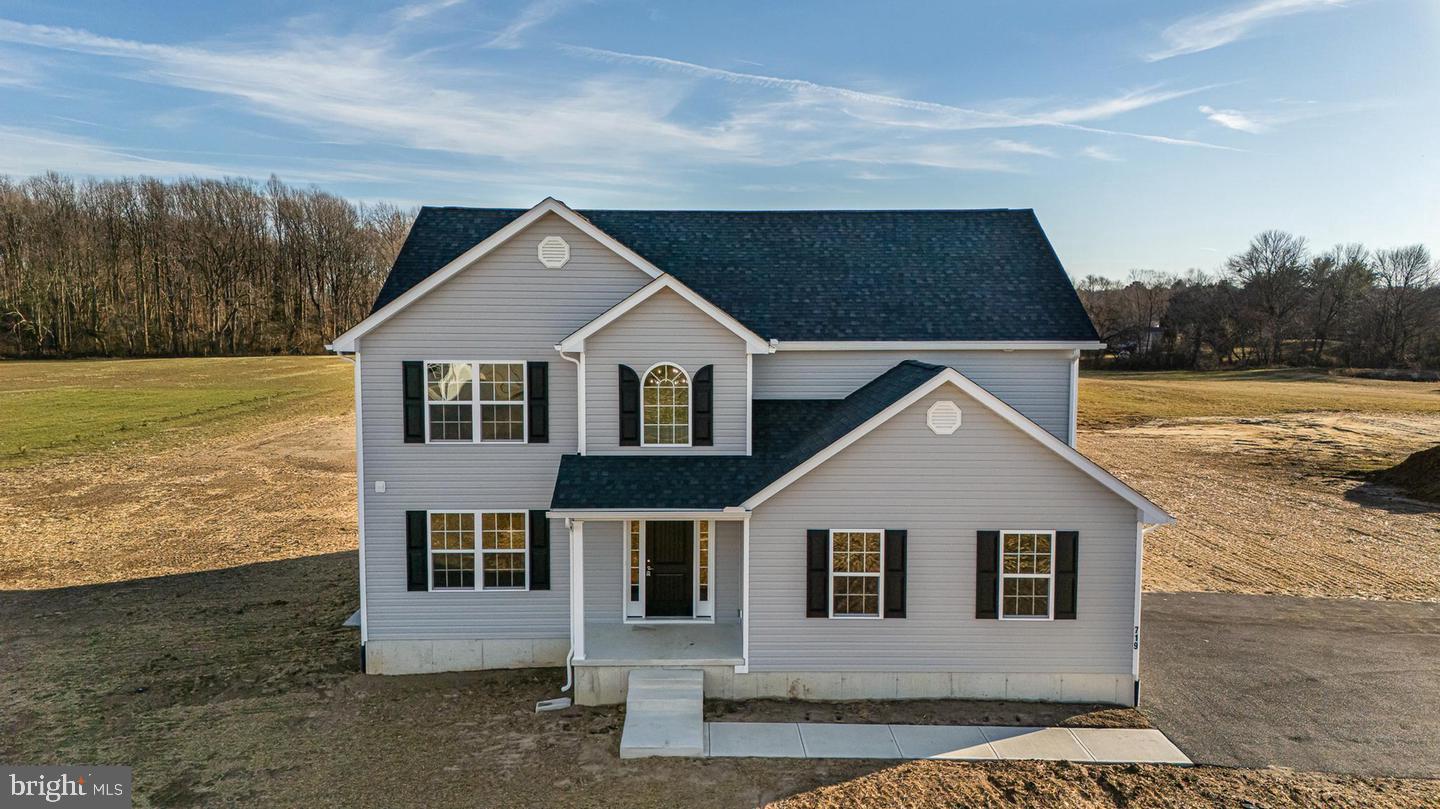 Discover the freedom of country living with no HOA and no Deed Restrictions on this stunning custom home situated on a private, wooded 0.76-acre lot including a 30 x 40 Pole Barn Garage. Conveniently located near Route 113, Route 1, and Delaware’s beautiful beaches, this property offers endless possibilities—bring your boat, RV, add a pool, or create the outdoor oasis you've always envisioned. Offering approximately 2,400 square feet of thoughtfully designed living space, this 4-bedroom, 2.5-bath home combines modern style with everyday comfort. Luxury vinyl plank flooring enhances the foyer, kitchen, breakfast area, and bathrooms, while the bright, open-concept floor plan is perfect for both entertaining and daily living. The spacious family room flows seamlessly into the gourmet kitchen, featuring 42-inch soft-close cabinetry, quartz countertops, and a stainless-steel appliance package. At the front of the home, a versatile flex space provides the ideal setting for a formal dining room, home office, or additional living area. Upstairs, retreat to the expansive primary suite complete with a spa-inspired en suite bath featuring a soaking tub, oversized shower, double vanity, and generous closet space. Three additional bedrooms, a full hall bath, and a conveniently located second-floor laundry room complete the upper level. The full unfinished basement offers unlimited potential—finish it to create additional living space, a home gym, media room, or workshop, or simply enjoy the abundance of storage. Don't miss this rare opportunity to own a beautiful custom home with room to grow and the flexibility to truly make it your own. Schedule your private tour today!