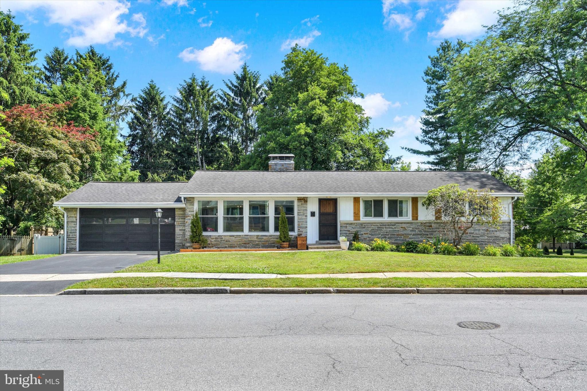 Welcome to this beautifully updated, move-in-ready ranch home offering more than 2,400 square feet of finished living space. Step inside to find durable luxury vinyl plank flooring that flows throughout the main level. The spacious living room fills with natural light from large windows and features a charming brick fireplace as its focal point. The completely remodeled kitchen boasts new cabinetry, butcher block countertops, stainless steel appliances, stylish tile backsplash, and a dedicated coffee/wine bar area. The adjoining dining area opens seamlessly to the kitchen and living room, creating an ideal layout for entertaining and gatherings. The main level also features three generously sized bedrooms and a beautifully renovated full bathroom complete with a new vanity, tub, toilet, and attractive tile flooring, allowing for convenient one-floor living. Just off the main living area, the sunroom provides the perfect place to enjoy your morning coffee while overlooking the private and spacious backyard. The fully remodeled and walk-out lower level significantly expands the living space and offers excellent flexibility for guests, multi-generational living, or use as an additional family or playroom! Featuring luxury vinyl plank flooring throughout, the lower level includes a newly added full bathroom with a beautifully tiled shower. Major improvements provide peace of mind, including a new water heater (2023), upgraded 200-amp electrical service and panel (2023), remodeled laundry room (2025), sunroom flooring (2024), vinyl fencing (2021), sealed driveway (2025), garage door opener (2024), and updated lighting and ceiling fans throughout (2025). Conveniently located near shopping, dining, parks, and major commuter routes, this turnkey home offers the perfect blend of space, style, and modern updates. Simply move in and enjoy!