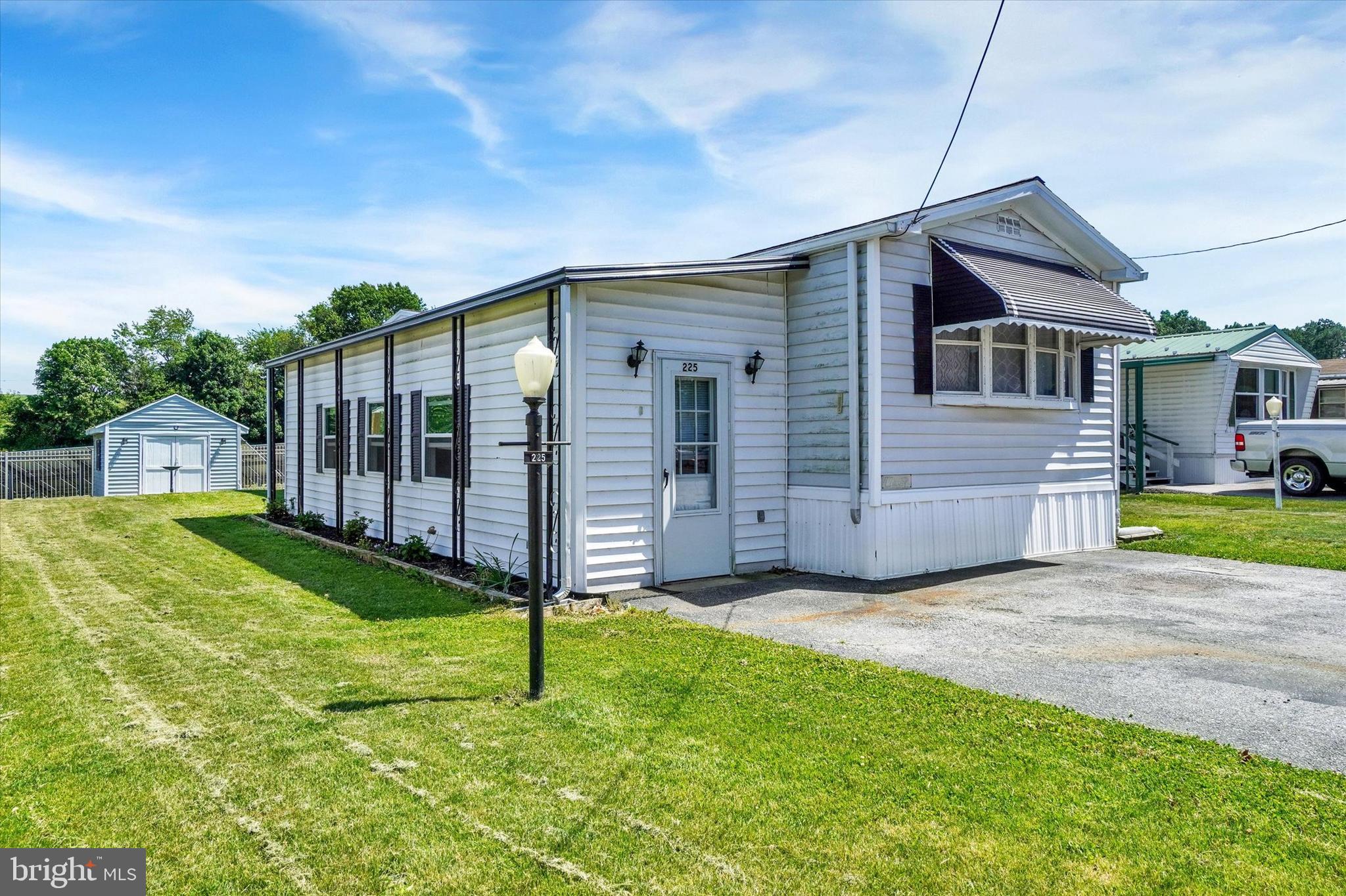 Thank you for taking the time to view 225 Country Ridge Drive in York, PA. Recent updates include a new roof in 2025, furnace and central air replaced in 2024, and washer and dryer replaced in 2025. The lot rent is $575 per month and includes sewer, water, and trash.  This home offers a nice layout with the primary bedroom, full bath, and closet on one end of the home. The center of the home features the living room, kitchen, and dining area. Down the hall are the washer and dryer, furnace, second full bath, and the second bedroom at the opposite end of the home.  The refrigerator, stove, washer, and dryer will stay. There is also a new range hood that will remain, although it has not yet been installed. Additional features include a level lot, rear shed, no homes directly behind the property, and a location near the end of a dead-end street within the mobile home park.  This is a 55+ community.