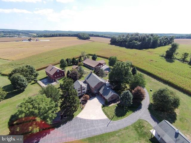 The private lane leads you to this incredibly peaceful estate w/rebuilt original log home & over 5000 sq ft of living space w/upgrades throughout.  23 acres of clean & green w/several out buildings to incl; bank barn, spring house, heated workshop & multiple car garage, dog kennel & more. Sunroom, 4 seasons rm, finished LL.  Bring your horses too! Addt'l lot could be removed to sell or build another home. Mins to Codorus State Park & Lake Marburg