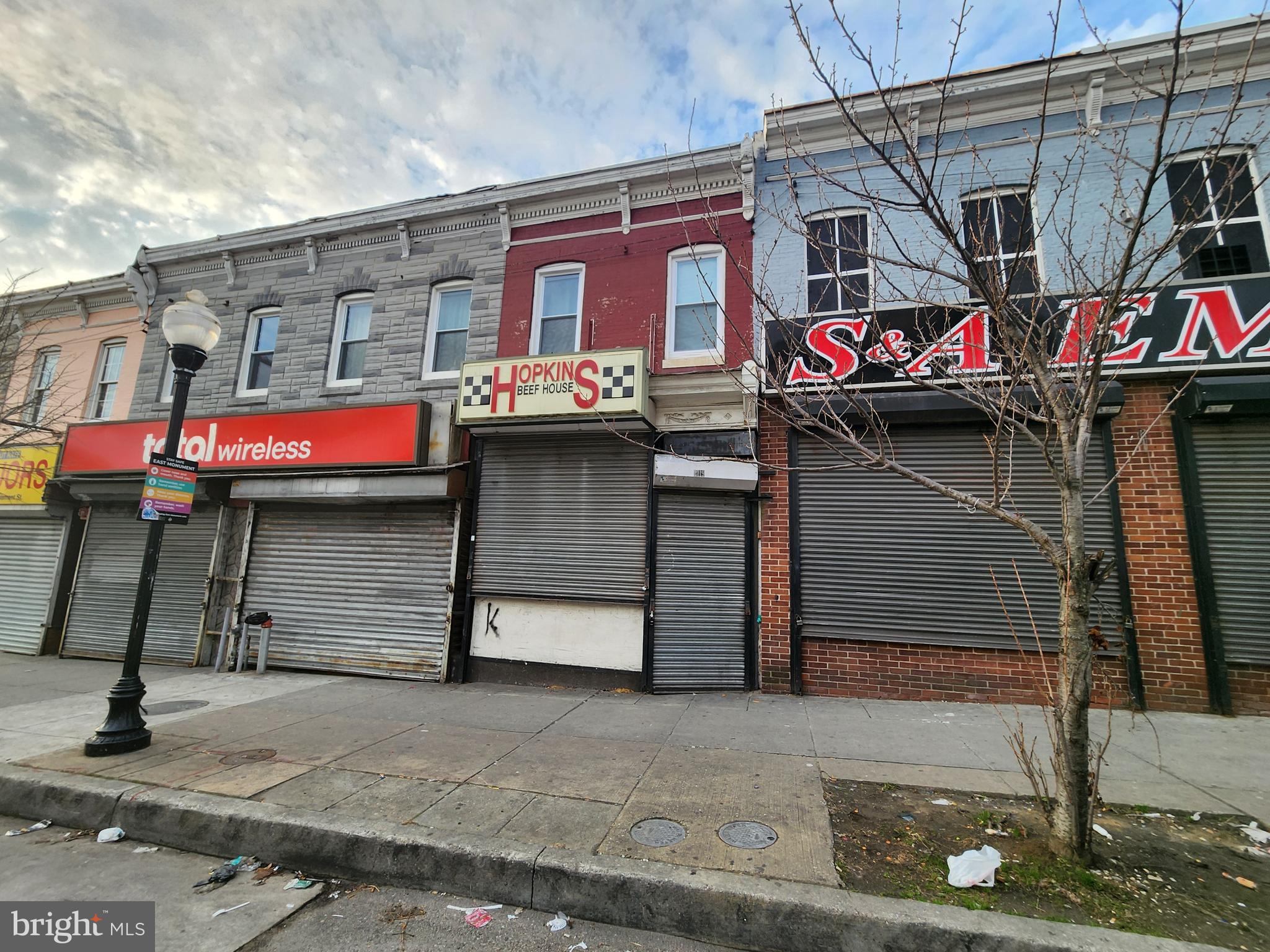 POST AUCTION! Make an offer, buy it now!Deposit: $15,000. Positioned along a well-traveled corridor in East Baltimore, this mixed-use property presents a compelling opportunity for investors, owner-operators, or value-add buyers seeking both commercial and residential upside.

The main level is configured for commercial use, featuring a storefront-style layout with direct street access, roll-down security gate, and open interior space suitable for a variety of business or retail uses. The property benefits from strong visibility and foot traffic, making it an attractive option for neighborhood-serving businesses or long-term commercial leasing.

Above, the upper level is set up as a residential unit, offering a separate living space that includes a kitchen area, full bathroom, and multiple rooms suitable for bedroom and living configurations. The layout provides flexibility for rental income, owner occupancy, or potential reconfiguration depending on buyer objectives.

Interior finishes throughout the residential portion include updated flooring, neutral paint tones, and modernized kitchen and bath elements. The bathroom features tiled shower surrounds, while the kitchen area includes cabinetry, countertops, and appliances in place.