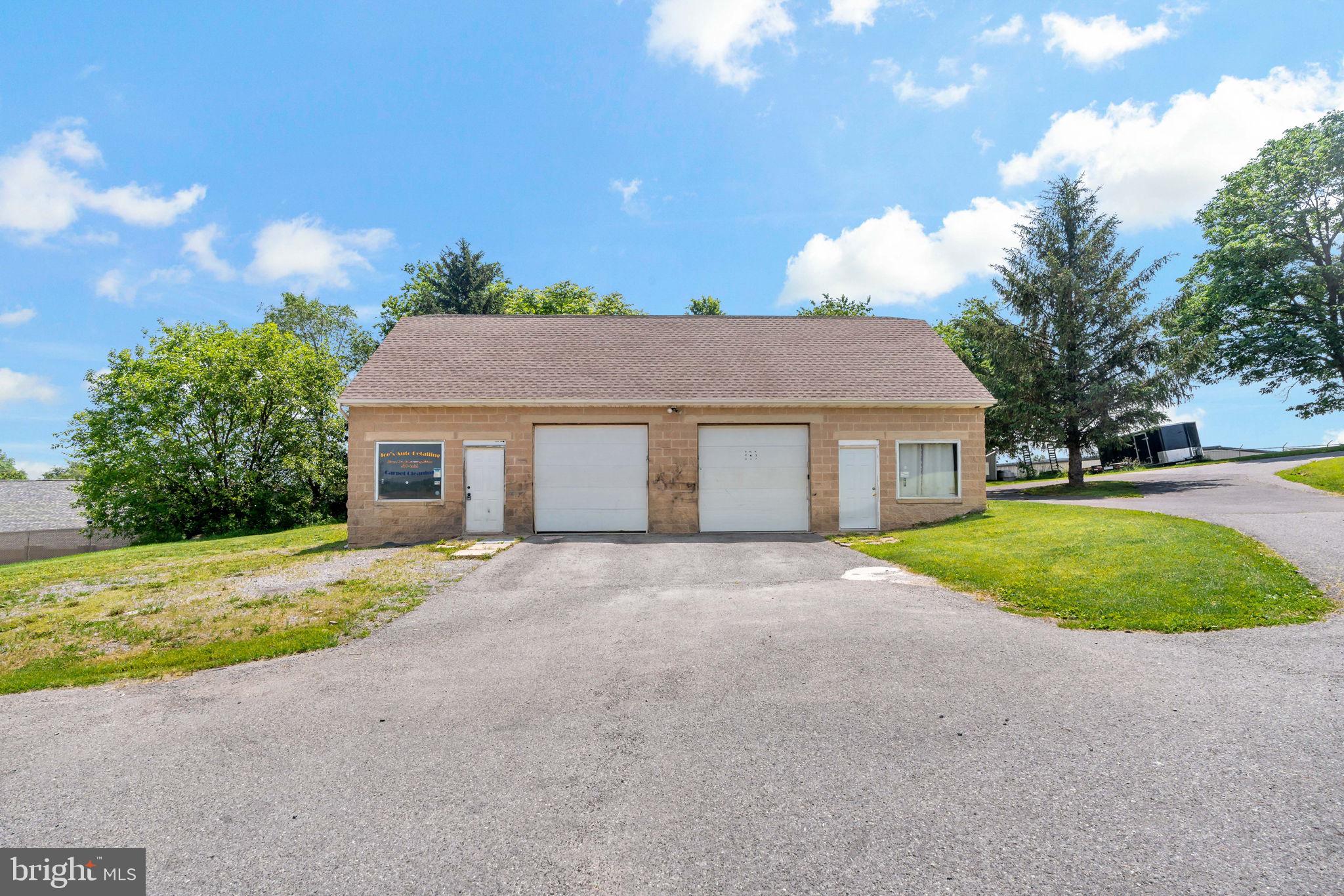Large 2 bay garage with office and 1/2 bath plus a storage room. Upstairs 2 bedroom 1 bath apartment.