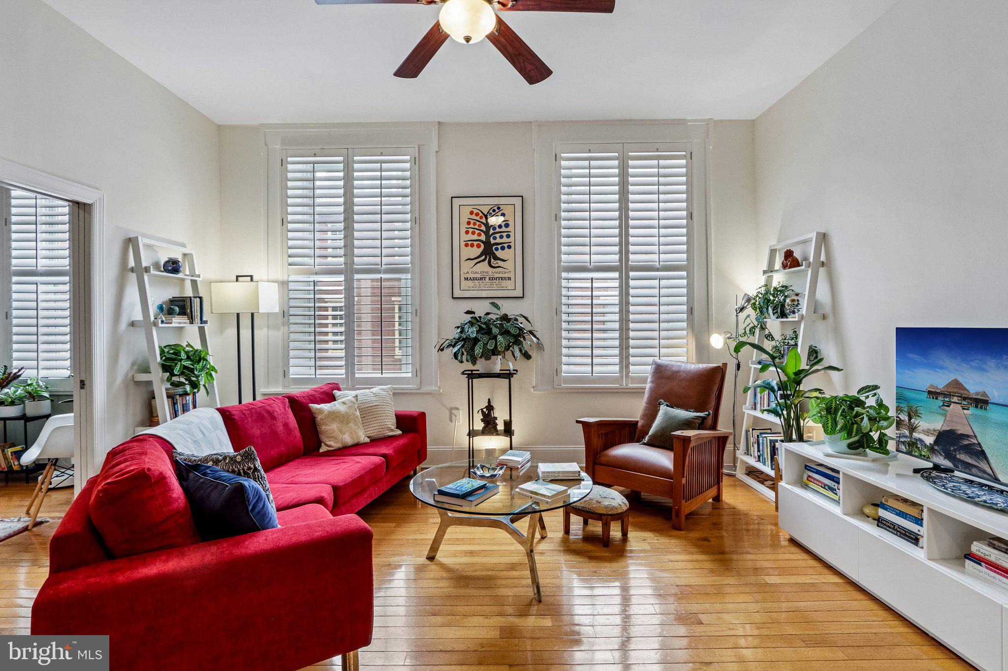 THIS BEAUTIFUL CONDO HAS A SPACIOUS PRIMARY BEDROOM AND A VERSATILE FLEX ROOM - PERFECT FOR A HOME OFFICE, DEN, STUDIO, OR GUEST BEDROOM. Located in the heart of Washington Square West—one of Center City’s most sought-after locations. Nestled within a secure building serviced by the Lenox Building’s 24/7 front desk (connected through the back of the building), this stunning second-floor condo blends modern updates with timeless style. Enter to a bright, open-concept layout highlighted by soaring 10.5-foot ceilings and an airy, expansive feel. The living room is bathed in natural light through oversized windows with elegant shutters, offering both privacy and soft, diffused sunlight. The seamless flow from living to dining creates an ideal space for entertaining, anchored by a beautiful kitchen featuring granite countertops, stainless steel appliances, and a breakfast bar with seating.  The generously sized primary suite is a true retreat, complete with oversized windows, a walk-in closet outfitted with an Elfa system, and the convenience of an in-unit Bosch stacked washer and ventless dryer. The ensuite bath features a walk-in shower. The versatile flex room sits just off the living area behind pocket doors and includes its own closet and ensuite bath. This home has been thoughtfully upgraded throughout, including a newer Bosch dishwasher, designer lighting in the dining room and over the breakfast bar, fresh paint throughout. Nest thermostat and smoke detectors, a Schlage smart lock, and updated bathroom fans and shower heads. Residents enjoy a host of valuable services covered by the condo fee, including commercial trash pick up 6 days a week, security cameras on exterior doors and entrance, 24/7 front desk service, package handling, and upcoming improvements such as a planned updated intercom system and an updated fire escape. A 24/7 parking lot offering hourly, daily and monthly parking is located on the same block for both owner and guest convenience.  Located just one block from the Kimmel Center and the Broad Street Line, and only a short distance to Rittenhouse Square, Old City, and some of Philadelphia’s best dining and shopping, this home places you at the center of it all. Plus multiple grocery stores, hospitals, and everyday conveniences are just blocks away. Experience elevated urban living in a vibrant, connected neighborhood—this is Center City at its finest. Mortgage savings may be available for buyers of this listing.