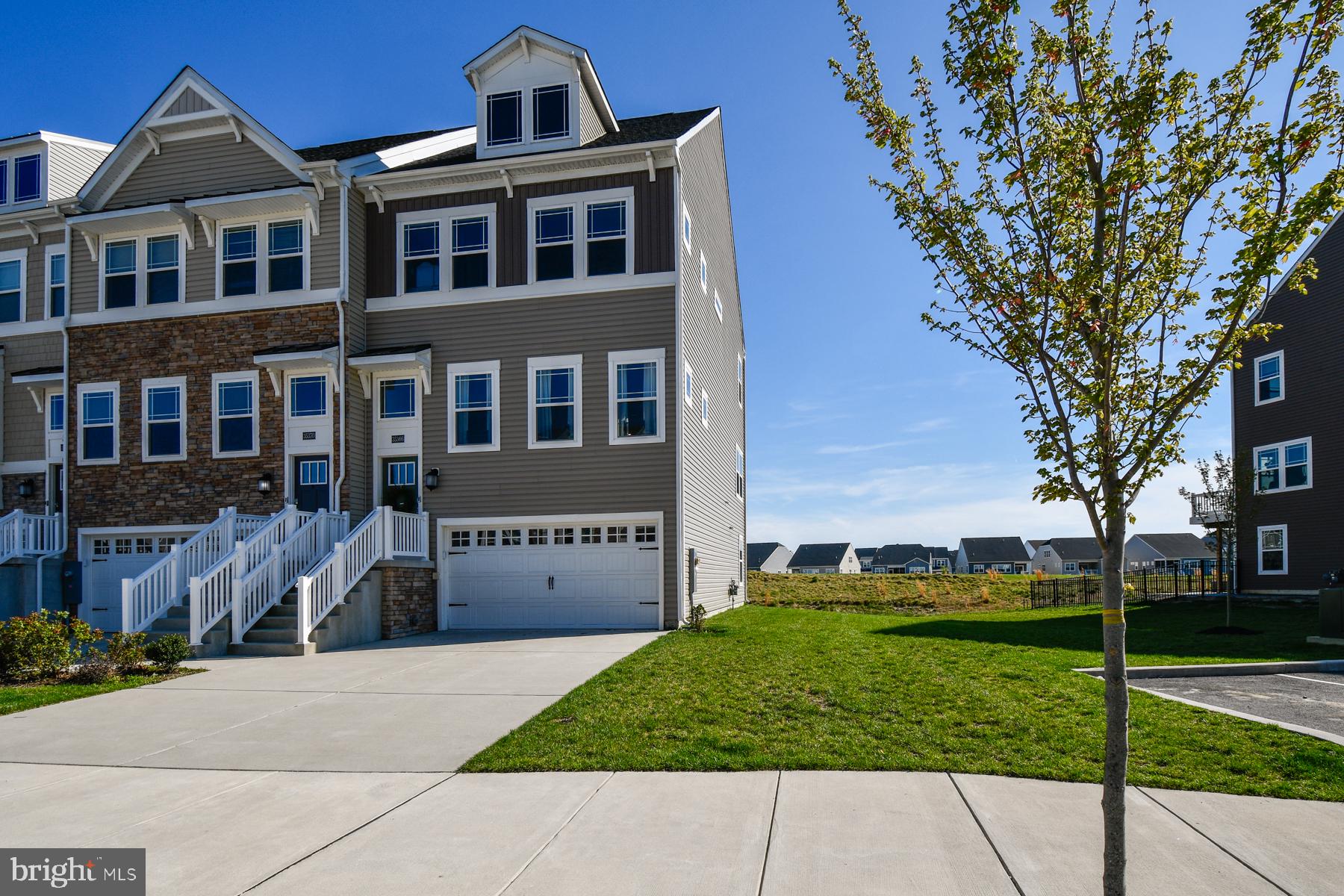 Nestled in the prestigious Plantation Lakes community, this exquisite end-of-row townhouse offers a harmonious blend of luxury and comfort, perfect for those seeking an elevated lifestyle. Built in 2022, this residence showcases modern craftsmanship and thoughtful design, ensuring a welcoming atmosphere from the moment you step inside. As you enter, you are greeted by an expansive open floor plan that seamlessly connects the gourmet kitchen, dining area, and family room. The kitchen is a culinary enthusiast's dream, featuring upgraded countertops, a spacious island, and top-of-the-line stainless steel appliances, including a built-in microwave, gas range, and self-cleaning oven. The combination of luxury vinyl plank and plush carpeting throughout the home adds warmth and sophistication, while recessed lighting and ceiling fans enhance the inviting ambiance. This home boasts three generously sized bedrooms, each designed with comfort in mind. The primary suite is a true retreat, complete with a walk-in closet and a spa-like bathroom featuring a stall shower. Step outside to discover a private balcony that overlooks beautifully landscaped gardens and the lush fairways of the adjoining golf course. The outdoor space is perfect for morning coffee or evening relaxation, providing a serene escape right at home. The community amenities are equally impressive, featuring a sparkling in-ground pool, tennis courts, and a fitness center, all designed to promote an active and social lifestyle. The property is situated on a well-maintained lot with rear and side yards, offering ample space for outdoor activities or gardening. With an attached two-car garage and a concrete driveway, parking is both convenient and accessible. Safety and security are paramount, with features including exterior cameras and smoke detectors, ensuring peace of mind for residents. The community also provides maintenance services, including lawn care and trash collection, allowing you to enjoy your home without the hassle of upkeep. Located in a vibrant neighborhood, this property is not just a home; it's a lifestyle. With easy access to walking trails, a clubhouse, and dining options, every day offers new opportunities for leisure and enjoyment. Experience the perfect blend of luxury, comfort, and community in this stunning townhouse-your dream home awaits.