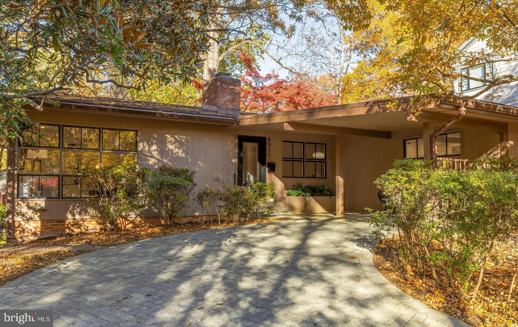 OPEN SAT & SUN 1-3PM. Rare light-filled mid-century modern gem in the heart of Somerset! This unique home features 4 bedrooms and 2.5 bathrooms and is nestled among mature trees steps from Little Falls Trail and a few short blocks from the Somerset Community Pool.

Step into a light-filled living area with hardwood floors, recessed lighting, and striking corner windows. A two-sided brick wood-burning fireplace connects the living and dining spaces, creating an airy and open environment ideal for entertaining. The spacious, sunken kitchen boasts new stainless-steel appliances, quartz countertops, island seating, and a large eat-in area perfect for dining and additional living space. The main level also hosts three bedrooms, including the sun-filled primary bedroom with its own en-suite bath. Two additional bedrooms share a bright hall bathroom.

The walk-out lower level features a generous above-grade recreation room with built-in bookshelves and direct access to the backyard through a large glass door. A fourth bedroom, finished laundry room, and a powder room are located adjacent to the rec room. Two additional large unfinished rooms provide abundant storage or the potential to easily create another bedroom or rec room.

Outdoor space abounds with a covered front flagstone patio, a long driveway with permeable pavers, a deep front yard, and a fenced-in backyard filled with mature plantings—ideal for gardening, play, or relaxation. A pull-down attic offers additional storage.

Extraordinary opportunity to live in the coveted community of Somerset. The Town, with its very own town hall, offers a community swimming pool, tennis courts, and basketball hoop. In bounds for award-winning Somerset Elementary School. Amazing proximity to Little Falls Trail right behind the home, with easy access to Kenwood and Norwood Park. Conveniently located blocks from the retail and dining in Friendship Heights, along with the Friendship Heights Metro,  Whole Foods, Bloomingdales, the New Trader Joe’s, and more. Don’t miss this unique, move-in ready home!