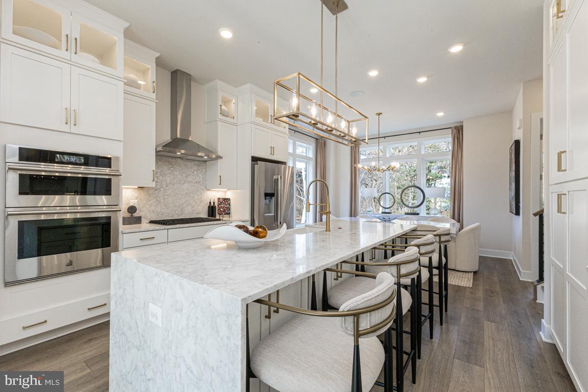 (lot 47) Sept/Oct delivery.  Brand new 4-level townhome in the best location in Reston!  Experience all that living in Reston has to offer, and walk to the W&OD Trail, Reston Town Center, metro stations and the new Reston Row Plaza.  First floor features a bedroom with full bath.  Main level boasts 10' ceilings with tons of windows, an oversized island and gourmet kitchen complete with full size pantry and coffee bar.  Great Room with fireplace overlooking the outdoor sky lanai covered balcony, perfect for enjoyed morning coffee in a private quiet space.  3rd floor features a stunning Primary Suite with dual walk-in closets and en-suite bath.  2 additional bedrooms, full bath, and laundry room complete this floor.  Top level is the best part - rooftop terrace with interior loft, powder room and wet bar.  Enjoy sunsets on the covered terrace. PHOTOS OF MODEL HOME