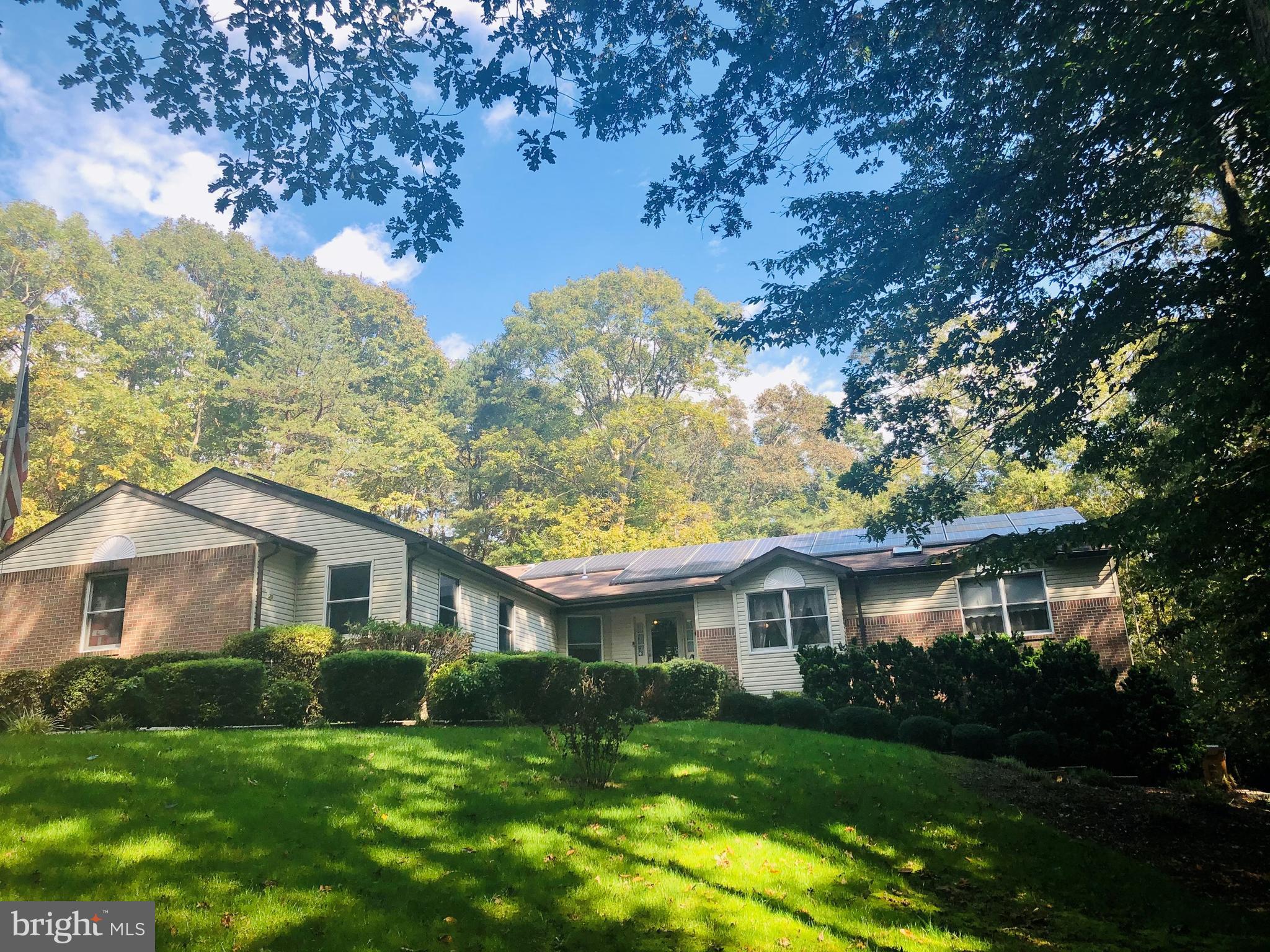 Beautiful single level living  on 3+ acres! You will be pleasantly surprised of the size of this 3500+ square foot home with two (2) FULL KITCHENS in Southern Waldorf! Over 3 wooded, private acres with 3 bedrooms and 3 full baths on the first floor and 2 bedrooms and 2 full baths in the lower level and 2 car side load garage on a wooded, private homesite.  You walk in the front door to a formal living room to the right and the great room is straight ahead with a brick gas fireplace and a very open concept and a tall vaulted ceiling.  Kitchen is in the center of the home with an island, granite countertops, stainless steel appliances and open to the dining room and great room.  Just off the back of the great room is a four seasons sunroom that opens to a side deck.  The owner's suite & private bath is on the opposite side of the two secondary bedrooms & full baths.  The lower level is finished with another full kitchen with cooktop & double wall ovens, 2 large bedrooms & 2 full baths, large great room w/brick gas fireplace and dining area.  NO HOA!