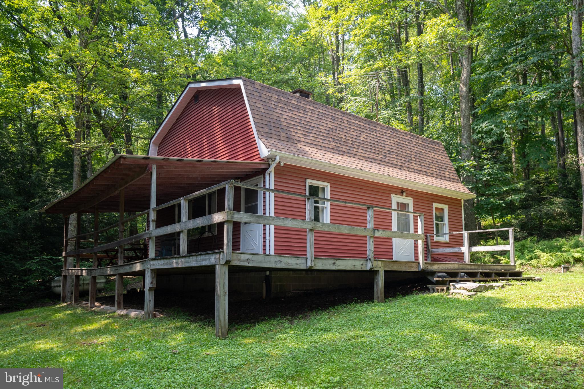 Tucked away on 1.84 wooded acres, this charming 3 bedroom, 1.5 bath home offers the perfect blend of privacy, comfort, and rustic appeal. The inviting living room features a gorgeous stone fireplace that creates a warm and cozy gathering space. Surrounded by mature trees, the property provides a tranquil retreat with plenty of room to relax, entertain, or simply enjoy the outdoors. Adding to the appeal of this serene setting, a community pond offers a peaceful place to take in the scenery and appreciate the natural beauty of the area. Outside, you'll find a spacious barn, perfect for storage, hobbies, a workshop, or housing outdoor equipment. Whether you're looking for a full-time residence or a weekend getaway, this property offers privacy, rustic charm, and endless potential in a beautiful natural setting.