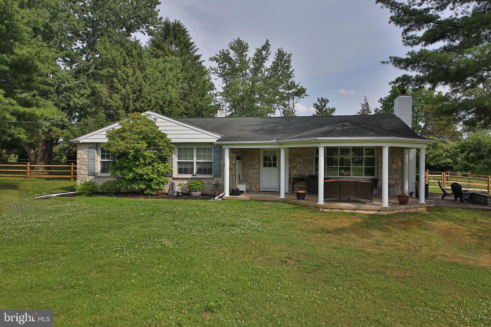Tucked away on two picturesque acres, this charming 3-4 bedroom, 2 full bath ranch home offers the perfect blend of privacy, peaceful surroundings, and everyday convenience. Enjoy sweeping views of the countryside, mature wooded borders, and a gently brambling creek that adds to the natural beauty of the property.
Inside, you'll find hardwood floors throughout, a spacious living room with stone gas fireplace, and a formal dining room.  Eat-in kitchen features an oversized window overlooking the backyard, bringing the beauty of the outdoors inside. One of the bedrooms is currently designed as a closet/dressing room with access to the attic, offering flexibility to suit your lifestyle.
The outdoor living spaces are just as impressive. An extra-wide covered front veranda is the perfect place to unwind with your morning coffee or watch the deer wander through at dusk. Just off the kitchen, an expansive composite deck provides plenty of room for entertaining, dining, or simply taking in the peaceful views. The fenced backyard is ideal for four-legged family members, gardening enthusiasts, or outdoor games.
The full basement offers endless possibilities with abundant storage, hobby space, laundry and utility areas, plus convenient Bilco door access. A large garden shed and an oversized driveway provide plenty of room for tools, equipment, and visiting guests.
Recent improvements include a new composite rear deck and central air in 2024, along with a generator, water heater, and rear yard fencing added in 2025, offering added comfort and peace of mind.
While you'll feel miles away from it all, you're just minutes from local favorites including the Butcher & Barkeep, The Energy Station, The Funky Bunny Coffee Shop, Lederach Piano Bar, and the charming shops and restaurants of Skippack Village. Upper Salford Park, with its walking and biking trails, playgrounds, and athletic fields, is also nearby.
If you've been dreaming of a home where you can enjoy the tranquility of country living without sacrificing convenience, this special property is ready to welcome you home. Come experience your own private slice of paradise.