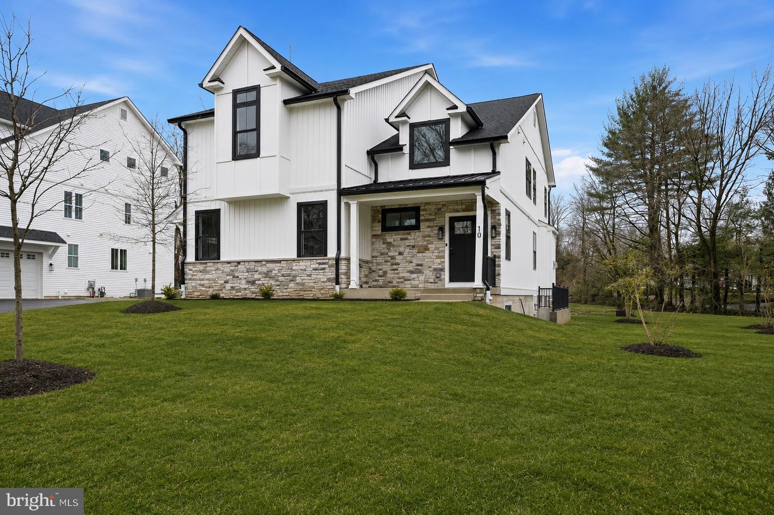 10 Churchville Lane is the largest of the three custom-built modern farmhouse residences in the Churchville Pointe enclave, offering newly constructed living space across three finished levels within the highly regarded Council Rock School District. The home features 4 bedrooms, 3.5 bathrooms, and an oversized two-car garage, combining generous proportions with quality construction and thoughtfully selected finishes.

Interior highlights include wide-plank white oak flooring, Andersen windows, recessed lighting, Cat-6 wiring for high-speed internet and sound, and pre-wiring for ceiling fans in multiple rooms. The kitchen serves as the central gathering space with custom cabinetry, quartz countertops, an oversized island, and Café stainless steel appliances including a wine refrigerator, complemented by practical features such as a butler’s pantry, walk-in pantry, and mudroom.

The bedroom layout offers comfortable separation, highlighted by a primary suite featuring a custom-fitted, oversized walk-in closet and a spa-style bathroom finished with large-format porcelain tile, soaking tub, glass-enclosed shower, dual vanities, and a private water closet.

Additional living space is provided by a daylight walk-up lower level with high ceilings, a full bathroom, and exterior stair access, offering flexibility for recreation, guests, fitness, or media use. Outdoor living includes a large elevated Trex deck, while major systems include a high-efficiency Carrier HVAC system and Bradford White tankless water heater. Builder is offering financing incentives through preferred lender which may include below market interest rates for qualified buyers.

Located just minutes from Richboro, Newtown, and New Hope, the home offers convenient access to shopping, dining, and commuting routes while maintaining the quiet character that makes Churchville one of Bucks County’s most desirable settings.