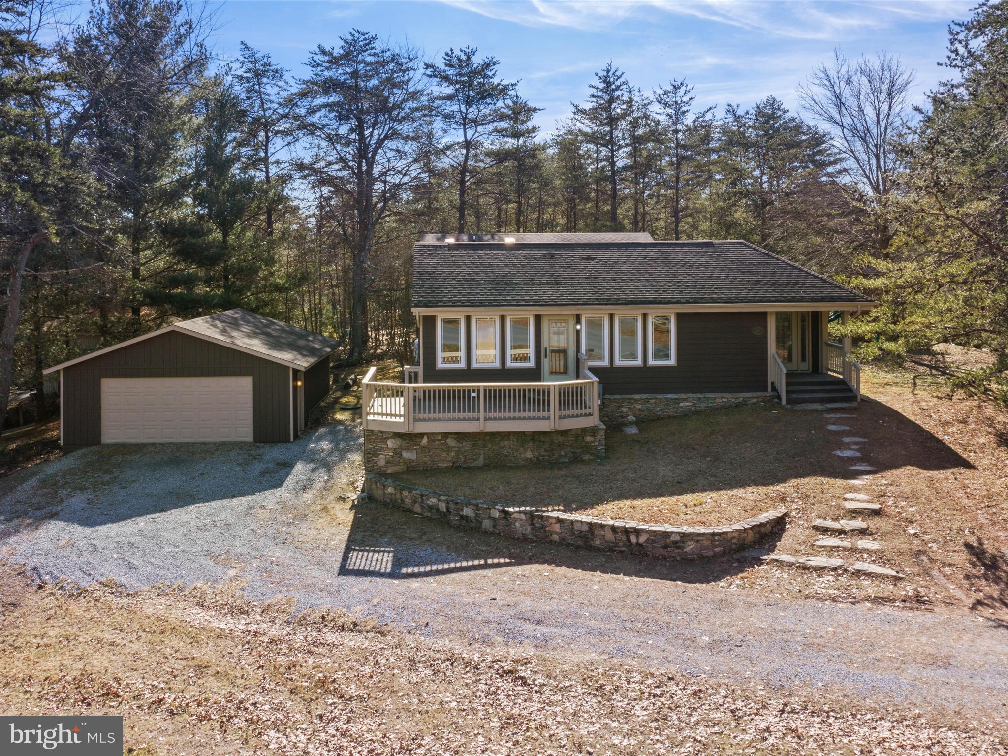Offer Deadline tomorrow, 2/13 at 6PM. Absolutely gorgeous rancher in the highly desired community of The Woods. This home is complete with 4 bedrooms, 3 full bathrooms, over 2500 total finished square feet, a detached two care garage, a huge deck, and two fireplaces. Updates include new stainless-steel appliances, new granite counter tops, a freshly stained exterior, two completely new bathrooms, fresh paint from top to bottom, new carpet, new LVP flooring throughout, new hardware and fixtures. This home is nestled on just under half an acre and is overlooking hole 2 of the Stony Lick golf course.