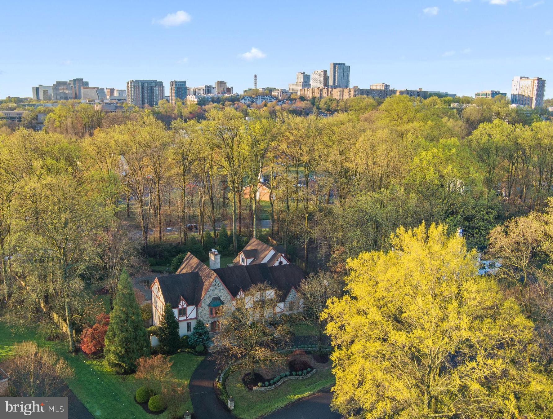 Welcome to your Tudor oasis nestled in a serene cul-de-sac, less than a mile away from the Silver Line Metro/Tysons, within the esteemed Spring Hill/Cooper/Langley High School pyramid. This grand residence boasts Tudor-style charm with modern amenities, offering a lifestyle of luxury and convenience.

As you approach, you're greeted by a circular drive leading to a stately four-car garage, providing ample parking for guests and family. The expansive extra-height fenced backyard beckons with its lush greenery, seasonal flowers, inground pool, Jacuzzi tub, and outdoor built-in grill—a perfect retreat for family entertaining and relaxation.

Inside the main residence, great living space awaits your personal touch. Step into the dramatic two-story great room, flooded with natural light from a magnificent wall of windows, creating an inviting atmosphere for gatherings or quiet evenings by the fireplace. Adjacent, a sunroom beckons, seamlessly integrating indoor and outdoor living.

For the discerning chef, the kitchen boasts Wolf and Sub-Zero appliances, along with high-end cherry-paneled cabinetry, ensuring culinary excellence with every meal. The dark cherry-paneled library offers a cozy retreat for work or study.

Upstairs, the indulgent master suite awaits, featuring a luxurious spa-like bath, tray ceiling, and custom-built closets, offering both elegance and practicality. Additional bedrooms also feature customized built-in closets throughout, providing ample storage for every need.

The lower level offers endless possibilities, with a full kitchen, an additional bedroom, a playroom for kids, and space for recreation or relaxation.

Plus, there is a separate guest house on the detached garage side, complete with a full kitchen, washer/dryer, full bathroom, and cathedral ceiling second-floor living, providing privacy and convenience for visitors or extended family members.

With its blend of timeless elegance and modern comfort, this Tudor retreat offers a rare opportunity to experience refined living within reach of urban conveniences. Don't miss your chance to make this extraordinary property your own. Schedule your private showing today.