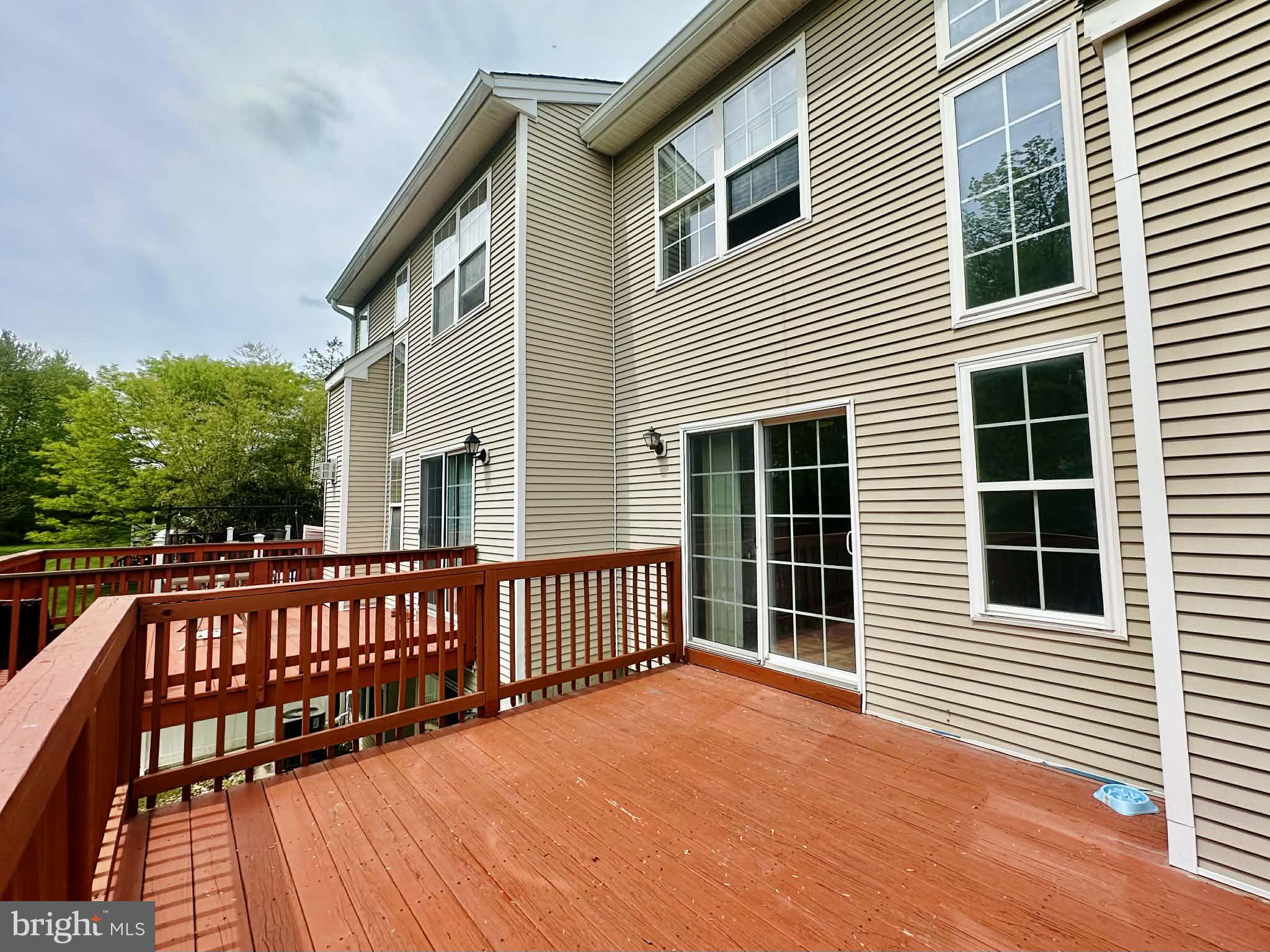 Welcome to 3369 Woodland Circle in the Villages of Huntingdon Valley, a highly sought-after community in the award-winning Lower Moreland School District, set on a premium lot backing to trees for added privacy.

The main level features hardwood floors, an open layout, and a two-story family room with a gas fireplace and floor-to-ceiling windows. The kitchen offers granite counters, eat-in space, and sliders to a private deck. A powder room completes the first floor.

Upstairs includes a spacious primary suite with walk-in closet and en suite bath, plus an additional bedroom and a flexible space where the laundry room was converted into a large closet, nursery, or office nook. A full hall bath serves the additional bedroom. Laundry is currently located in the basement, with hookups still in place upstairs for easy relocation. Carpet has been removed upstairs, offering a great opportunity to customize flooring.

The walk-out lower level provides additional living space, storage, and laundry. Flooring has been removed, offering a blank slate for your finishing touches.

The home has been mostly repainted and is ready for its next owner to bring their vision and make it their own.

Conveniently located near shopping, dining, and major routes. Don’t miss this opportunity to make it your own!