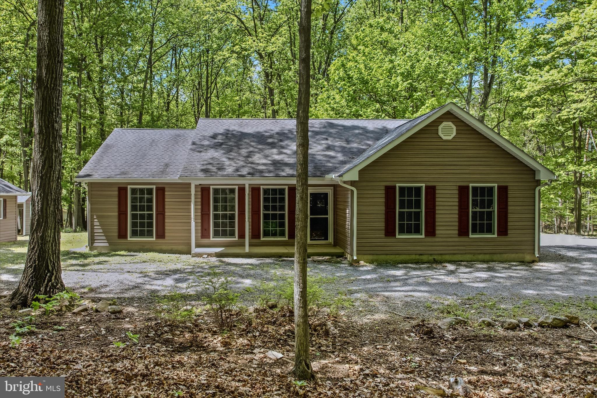 Nice rancher on nearly 3 acres.  Fresh paint and flooring are included. Plenty of space for storage in the out buildings on the property.  Close to downtown Berkeley Springs and Cacapon State Park also. Very serene location with the wooded lot.  Lots of natural light and a bonus sunroom are also great features.  Central heat and air, a covered front porch are great touches. A great place to call home and a must see!