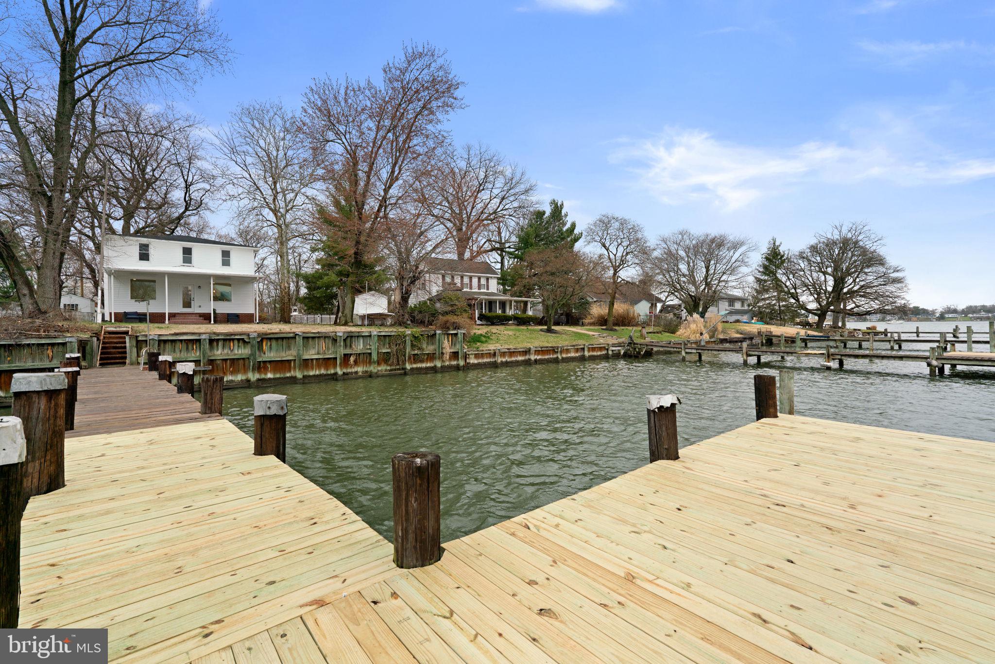 WATERFRONT for LESS than $600K! Welcome to a rare waterfront opportunity in Middle River—where peaceful living, beautiful water views, and modern upgrades come together in a newly renovated home that is simply stunning.

Perched on a quiet waterfront side street surrounded by long-time, well-maintained homes, this spacious three-level residence offers beautiful views of the bay and a lifestyle centered around the water. Oversized picture windows fill the home with natural light while capturing sweeping waterfront scenery throughout the day.

The main level features a large kitchen with sweeping water views, a dining room, and a living room designed for gathering and entertaining, along with a main-level bedroom and full bathroom. Upstairs, you’ll find three additional bedrooms—each with water views—and a second full bath. The finished lower level offers a recreation room, laundry area, another full bathroom, and flexible space that could serve as a fifth bedroom, home office, or playroom.

Boating and waterfront living are effortless here with deep water access from your private dock—perfect for kayaking, paddleboarding, crabbing, or heading out by boat to nearby waterfront restaurants like Bowley’s on the Bay.

This home has been extensively renovated down to the studs and fully permitted, offering the feel of a new build with updated electrical, plumbing, HVAC, roof, appliances, flooring, lighting, kitchen, and bathrooms.

An added bonus rarely found in this area: the sale includes TWO tax parcels, creating additional space, privacy, and long-term value. The additional parcel includes a large shed and significantly expands the property footprint.

Set on a large fenced lot with a huge covered patio overlooking the water and a finished basement rarely seen in nearby waterfront homes, this property offers the perfect blend of modern living and relaxed waterfront lifestyle.

Whether you’re looking for a primary residence, weekend getaway, or a home where every day feels like vacation, this is a waterfront opportunity you won’t want to miss.

NEW: 200 amp electrical service, plumbing throughout, HVAC system, roof, appliances, lighting, flooring, carpet, paint, kitchen, bathrooms, finished basement, and some new windows.

Addtional Parcel included is 10-A Grovethorn Road. This house is NOT in a flood zone, according to the FEMA map.  Flood insurance is not required.
