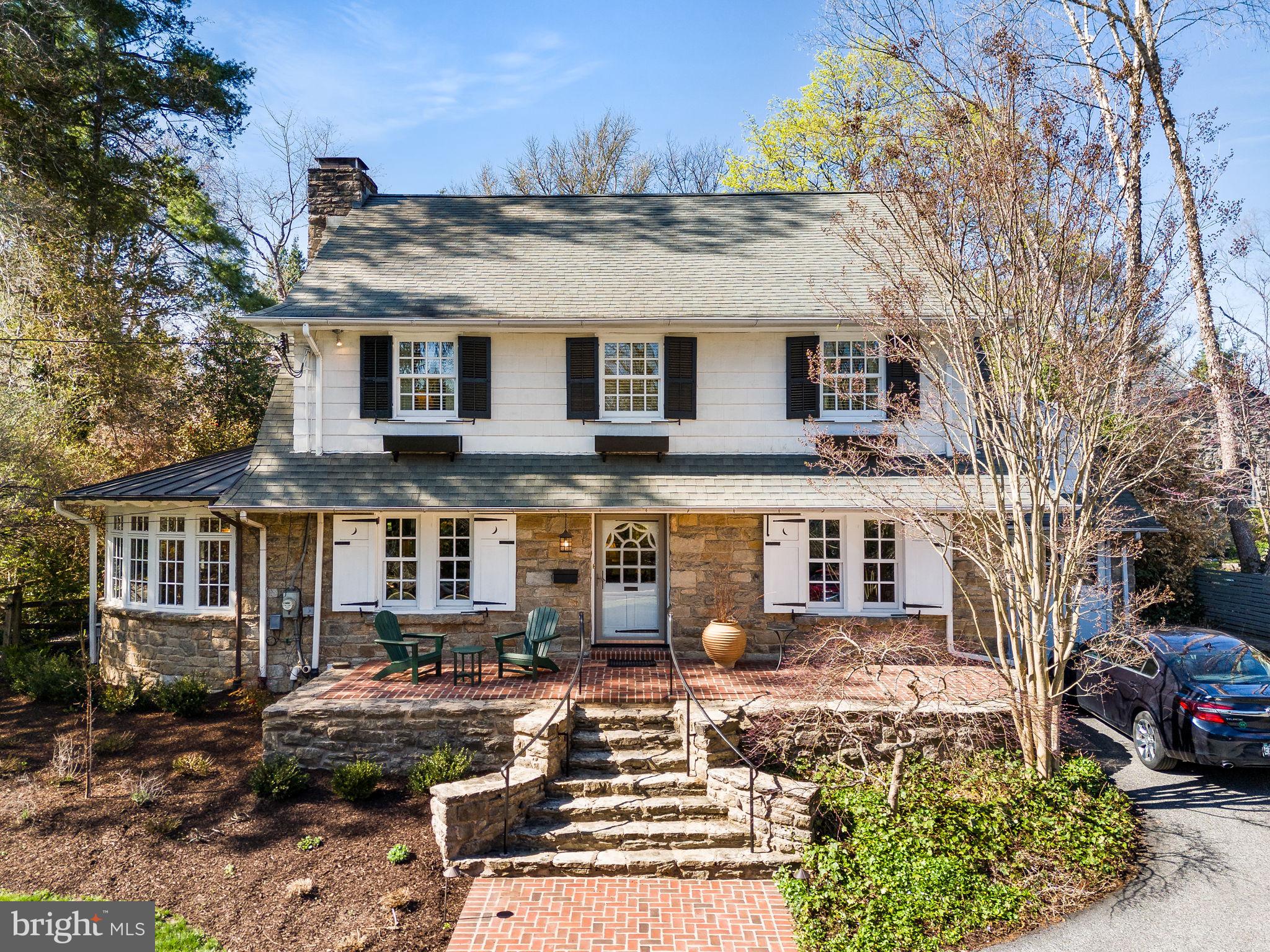 5 Ogden! Oh, what a beautiful home! With a deep front lot (.36acres in total), this classic Swarthmore stone center hall colonial oozes with charm and character. It starts at the front stone steps and brick patio and continues to the formal foyer. The formal living room, off to the left of the foyer, extends front to back, with French doors to the back patio. This room shows off the lovely hardwood flooring that is throughout the home and features an elegantly mantled stone fireplace with original Mercer tiles. You enter a sunroom from either side of the living room fireplace, where a serene, retreat awaits. The entire sunroom curves around a second wood paneled fireplace and mature landscaping outside keeps this room warm and inviting. Finished terracotta flooring adds to the appeal, and there is a seamed copper roof above. Flowing through to the formal dining room on the left of the foyer, notice the deep windowsills, corner hutch and crown molding and entry to the kitchen. The kitchen is a true cook’s joy! A custom paneled refrigerator, stainless wall ovens, gas cooktop and custom tile backsplash make cooking easy. And a large breakfast area sits under a panel of windows to the patio. A fantastic and unexpected mudroom is open to the kitchen and adds so much! Do not miss the hidden laundry chute, potting counter with copper sink, desk, and floor to ceiling cabinetry. There are so many ways to use this space! 
The primary bedroom on the second floor has much to offer as well! Flooded with light from the front and back and anchored by custom built in bookcases at either end, this beautiful bedroom includes a small step-down sitting room and spacious ensuite Bath complete with shower, soaking tub, double bowl sinks, custom cabinetry, walk in closet, and the laundry chute to the mud room.  This is truly a joy and such a surprise in a home of this age! There are three generously sized secondary bedrooms, one with Hall Bath access. 
The third floor includes a finished yoga studio/office/fifth bedroom with skylights and carpet.  A large storage room is on this floor as well. 
The finished basement is a perfect rec room with a painted floor, storage cabinets, a linen closet and laundry area tucked away behind louvered doors.  An unfinished area includes a utility sink and ample shelved and open storage space. NEW gas HVAC, gas hot water. 
The tile and flagstone patio is accessed from the living room and mudroom and is terraced, leading  up to sheltered dining area under a wisteria pergola. Fencing surrounds the back yard for the family pets.  And there is interior access to the garage from the kitchen as well.
With curb appeal abounding, 5 Ogden Avenue enjoys all that Swarthmore has to offer with fair, food truck and parade days so much fun. And, of course, the local shops, public Library, Swim Club, CO-OP grocery store, and train station. Served by prestigious Blue Ribbon Wallingford-Swarthmore schools, you are just twenty minutes from Philadelphia International Airport by car, and thirty minutes from downtown Philadelphia or Wilmington. 
Beauty and history seeped in carefully curated landscaping.   Just one visit and you won’t want to say goodbye!
And for another look, watch the video, attached. Floorplans are on their way!