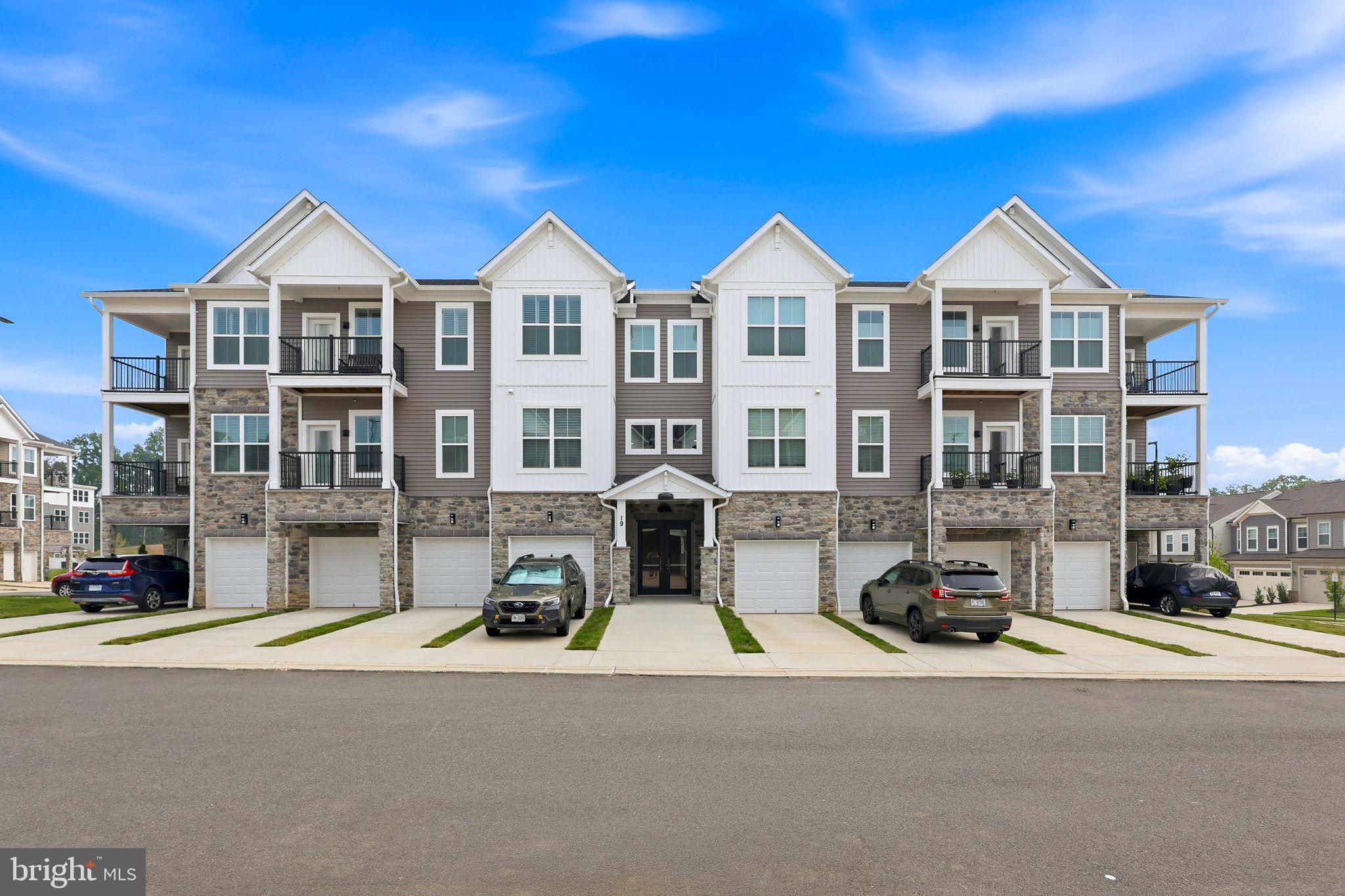 Welcome to Cascades at Embrey Mill. This stunning one-level active adult condo offers everything you need for easy, elegant living. You'll appreciate the one-car garage with direct entry, plus extra storage for all your essentials.
Step into a spacious foyer with tray ceiling and open floor plan defined by luxury vinyl plank flooring and designer finishes. The chef-inspired kitchen features a large island with bar seating, quartz countertops, custom backsplash, stainless steel KitchenAid appliances, and gray cabinetry with pull-out shelves. A generous walk-in pantry keeps everything organized, and the seamless flow to the dining area and bright living room makes entertaining effortless.
A built-in office with custom cabinetry gives you a dedicated work-from-home space. The laundry room is convenient and ready to go with brand-new washer and dryer included.
The owner's suite is your private retreat, complete with spacious walk-in closet and an elegant bath featuring dual quartz vanity, frameless glass shower, private water closet, and upgraded tile. Two additional bedrooms and full hall bath provide flexibility for guests or whatever you need.
Smart home features include programmable thermostat, keypad entry, and CAT6 wiring for modern living. Enjoy tree-framed sunsets from your private balcony, and take advantage of custom remote-controlled blinds throughout.
Cascades residents enjoy exceptional amenities: clubhouse, resort-style pool, fitness and yoga studio, patio with fire pit and grills, plus pickleball and bocce courts.
A well-designed home ready for you.