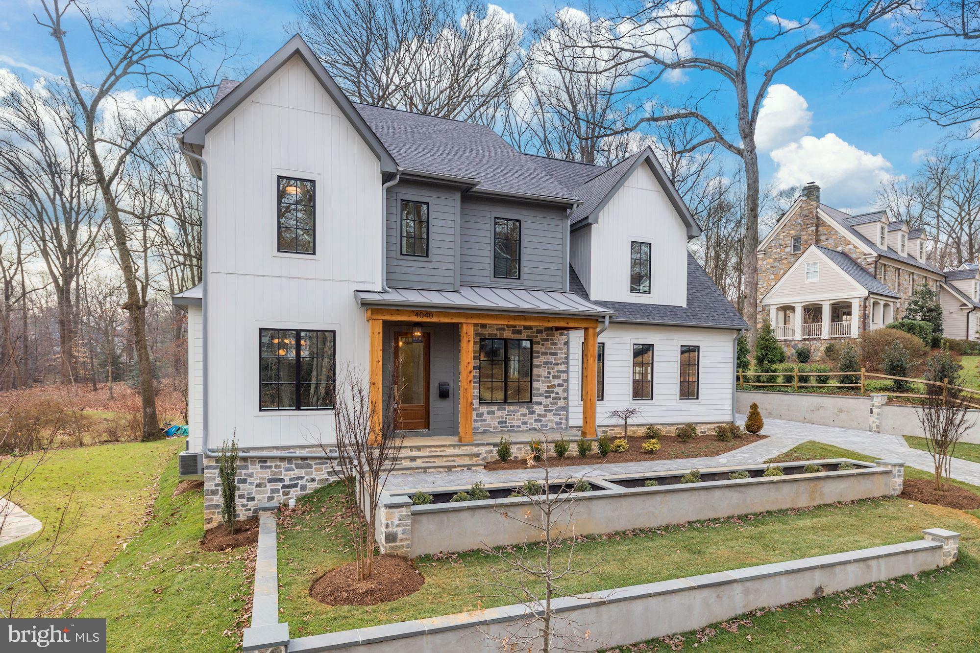 Almost 6,000 total SF on a quiet no through street. Backing to Gulf Branch Nature Center and Glebe Road Park, Brush Arbor's transitional interpretation of a Belgian Farmhouse represents a new standard in the application of traditional elegance and contemporary convenience. Shiplap and Stone, white oak accents + floors, custom JeldWen windows and exterior doors, designer finishes including lighting by Circa, CurreyCO + Visual Comfort.  Architectural details seamlessly designed throughout as arched doorways integrate with perfect nooks and built-ins. Incredible kitchen with custom cabinetry and massive island and butler's pantry. Large mudroom with desk area, family powder room, and walk-in pantry. Luxury master suite with volume, beamed ceilings and treehouse-like views. Incredible master bath and master closet, luxury folding console and pendant fixture. Covered porch with fireplace pre-wired for electric screens. Daylight, walk-out basement. Lower level bar, exercise room, large tiered yard with incredible tree views, adorable built in details like a lit reading nook, plentiful sitting areas on bedroom level. Attached 2-car plus Detached 1-car Garage. Don't miss your chance to own a 2020 Brush Arbor Home.
