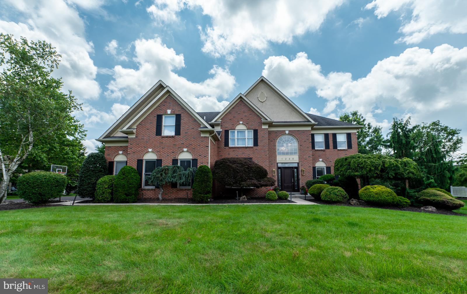 Elegant Brick Colonial, 4 bedrooms, 4 ½ baths, w/4,000+ sq ft of Refined Living space, situated on a Serene 59-acre lot in coveted Wissahickon School District. From the moment you step into the Sun-filled Foyer with Sweeping Grand Staircase, Custom woodwork and Gleaming Hardwood Floors, you’ll appreciate its timeless Sophistication. The Gourmet eat-in Kitchen is a Chef’s Dream, 5-Burner Gas Cooktop, Granite Countertops, Double Wall Ovens, Stainless Steel appliances, Walk-in Pantry, and Central Island which Invites gathering and effortless meal prep. Custom Sliding door opens to the Lush Treelined Professionally Landscaped Backyard featuring a large Trex Deck. The Open Floorplan flows into Stunning two-story Family Room, anchored by Floor to Ceiling Marble Gas Fireplace, Wet bar, Back staircase and Dramatic Wall of Windows. Spacious Living and Dining Rms are perfect for entertaining. Main Floor Study w/Glass French Doors with direct access Full Bath offers a flexible space. Powder Rm and Laundry/Mudroom complete the 1st floor. Upstairs the Luxurious Owners’ Ensuite w/Sitting area, Vaulted Ceiling, Expansive Walk-in Closet is sure to Impress - Fabulously Updated Spa Bathroom boasts - Oversized Seamless Glass shower, Relaxing Soaking Tub and Custom Vanities. Second floor includes – Nicely sized 3 Bedrooms, one of which is an ensuite and along w/hall bathroom. Conveniently located near Springhouse Village, Whole Foods, Starbucks, English Village, SEPTA train station, Rt 309, PA Turnpike and area Nature Trails.